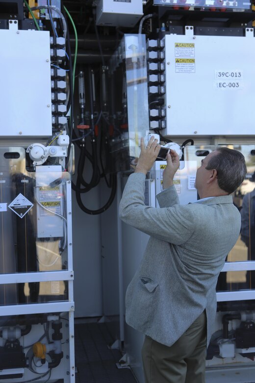 William Torre, a member of a Korean delegation, takes a picture of a Primus Power battery during their visit aboard Marine Corps Air Station Miramar, Calif., Feb. 17. A Primus Power battery is a liquid battery used for energy storage on the electric grid aboard the installation. The delegation consisted of 14 South Korean citizens and two American citizens. (U.S. Marine Corps photo by Cpl. Kimberlyn Adams/Released)