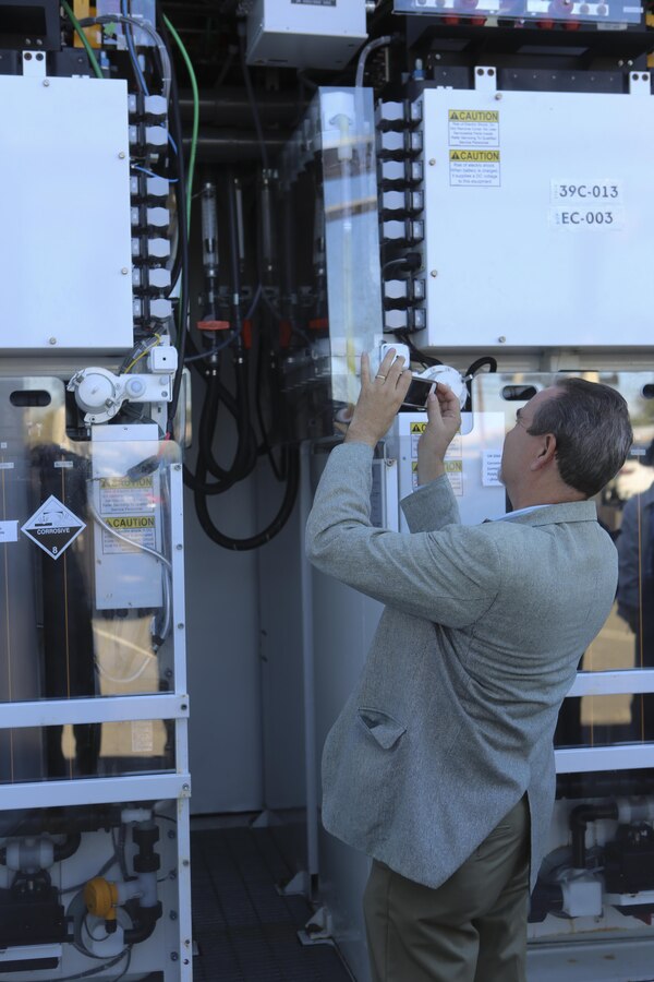 William Torre, a member of a Korean delegation, takes a picture of a Primus Power battery during their visit aboard Marine Corps Air Station Miramar, Calif., Feb. 17. A Primus Power battery is a liquid battery used for energy storage on the electric grid aboard the installation. The delegation consisted of 14 South Korean citizens and two American citizens. (U.S. Marine Corps photo by Cpl. Kimberlyn Adams/Released)