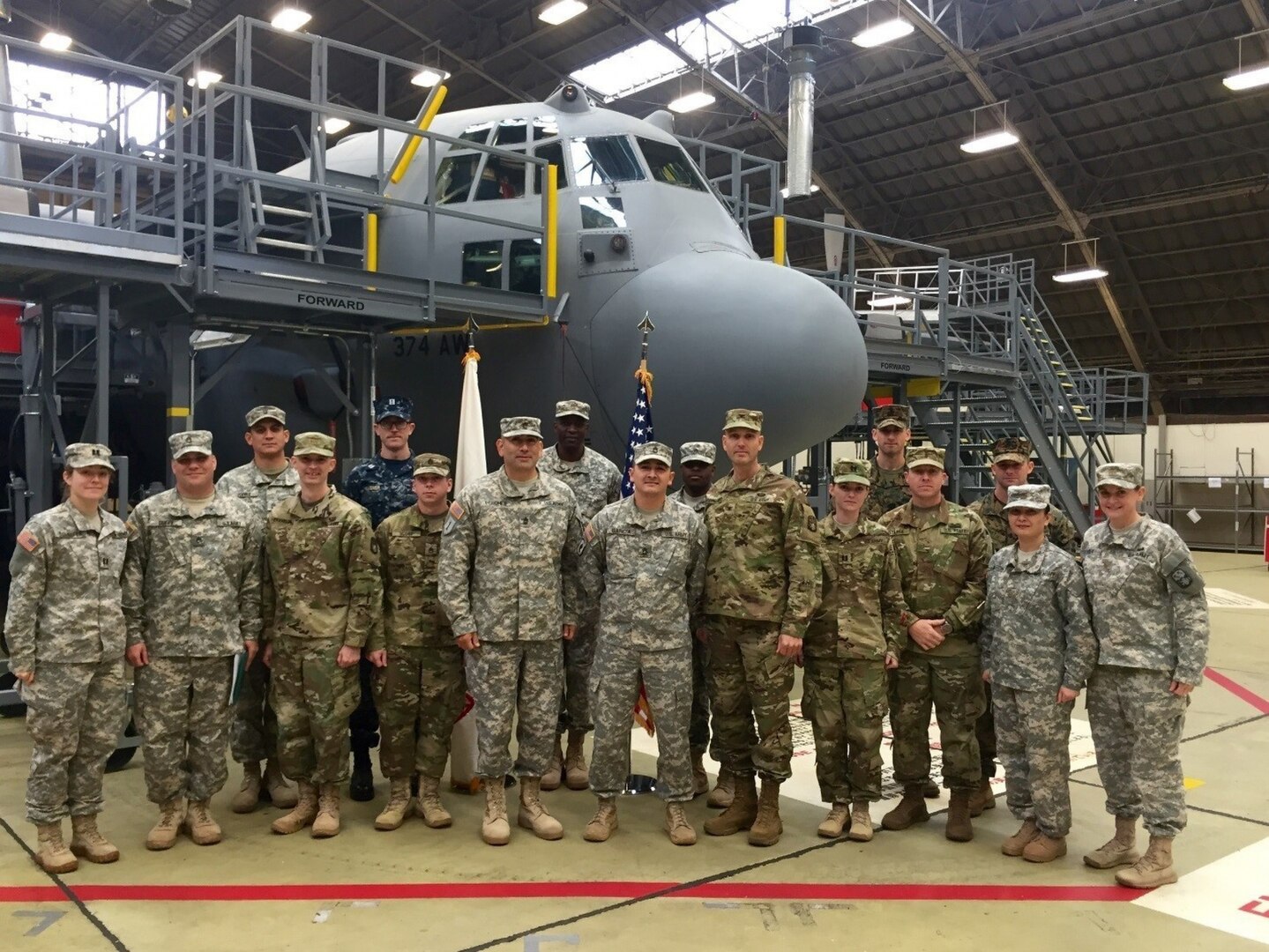 The joint forward team members for Keen Edge 16, several of which are with the 94th Army Air and Missile Defense Command, pose for a team picture, Jan. 28, 2016, inside a hangar at Yokota Airbase, Japan. Pictured in the back row from left to right are, Sgt. 1st Class Michael Jones, Lt. Kyle Wagner, Maj. Carlos Rockshead, Sgt. Andra Watson, Lt. Patrick Lauer and Gunnery Sgt. Bryan Mott. Pictured in the front row from left to right are Capt. Emily Schaefer, Staff Sgt. Ian Duffy, Maj. Matt Chambless, Staff Sgt. Randolph Scott, Master Sgt. Victor Perches, Sgt. 1st Class Missael Garcia, Col. Douglas Waddingham, Capt. Sandra Wilson, Chief Warrant Officer 2 Christopher Staffa, Maj. Shannon Aseron and Maj. Juene Rader. 
