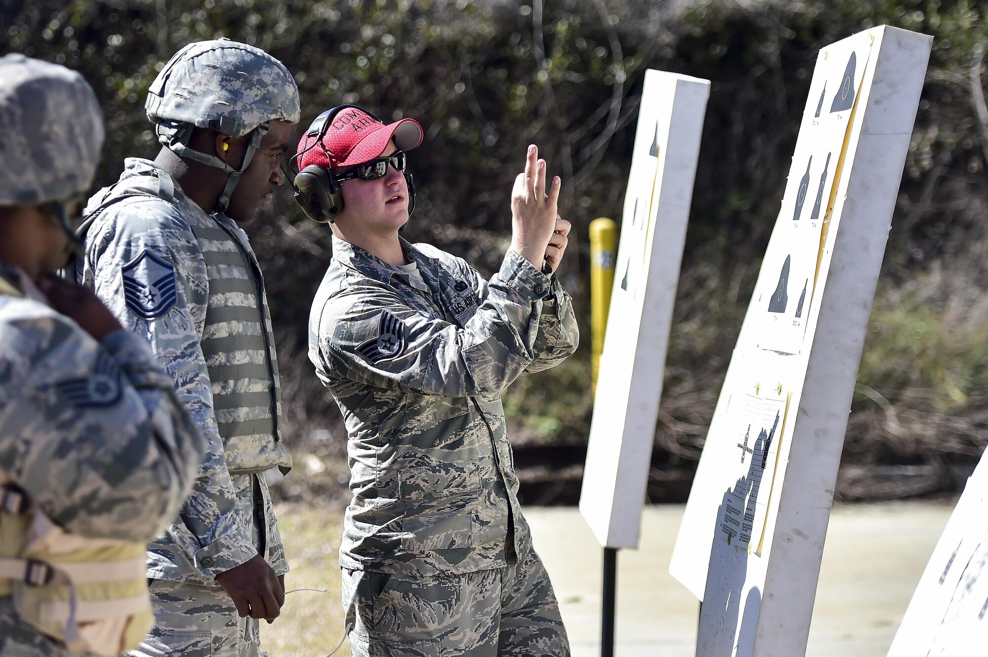 Staff Sgt. Thomas Hartine, a combat arms training and maintenance instructor with the 1st Special Operations Security Forces Squadron, gives shooting advice at the CATM range, Hurlburt Field, Fla., Feb. 16, 2016. CATM instructors train and qualify Airmen on required weapons needed for deployments. (U.S. Air Force photo by Senior Airman Jeff Parkinson)