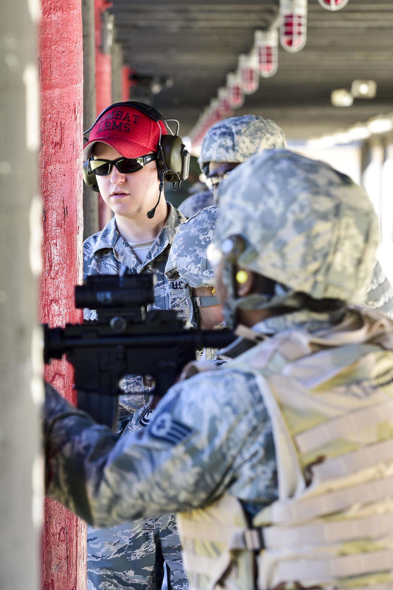 Staff Sgt. Thomas Hartine, a combat arms training and maintenance instructor with the 1st Special Operations Security Squadron gives shooting advice at the CATM range, Hurlburt Field, Fla., Feb. 16, 2016. As Hartline watches the students’ techniques and performance, he takes mental notes on how to improve their skill set. (U.S. Air Force photo by Senior Airman Jeff Parkinson)
