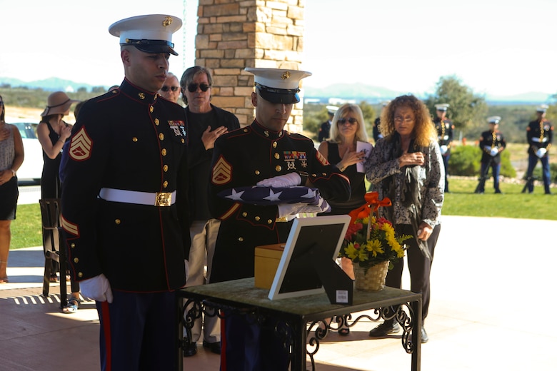 Marines stationed at Marine Corps Air Station Miramar place the ashes of the deceased on display during a funeral aboard Miramar National Cemetery, San Diego, Feb. 16. Funeral detail honors a military tradition for fallen active-duty members and veterans alike. The tradition includes the playing of "Taps", the folding of an American flag to be presented to the next-of-kin of the deceased and the 21-gun salute. (U.S. Marine Corps photo by Lance Cpl. Harley Robinson/Released)