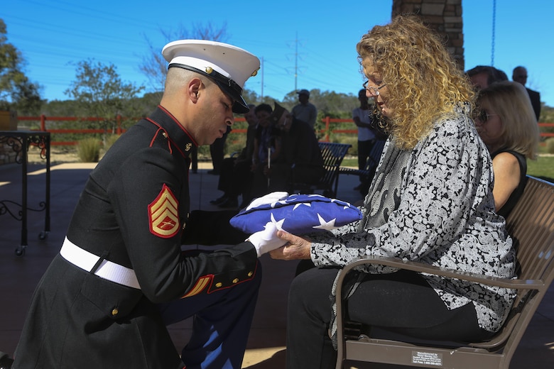 Staff Sgt. Caba presents the American flag to the daughter of the deceased during a funeral at the Miramar National Cemetery, San Diego, Feb. 16. Funeral detail honors a military tradition for fallen active-duty members and veterans alike. The tradition includes the playing of “Taps,” the folding of an American flag to be presented to the next-of-kin of the deceased, and the 21-gun salute. (U.S. Marine Corps photo by Lance Cpl. Harley Robinson/Released)