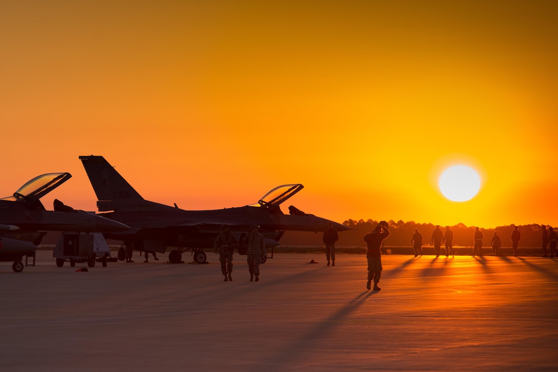 Airmen conduct an early morning search for debris on the flightline before daily operations on Eglin Air Force Base, Fla., Feb. 8, 2016. The airmen are assigned to the 158th Maintenance Squadron. Air Force photo by Airman 1st Class Jeffrey Tatro