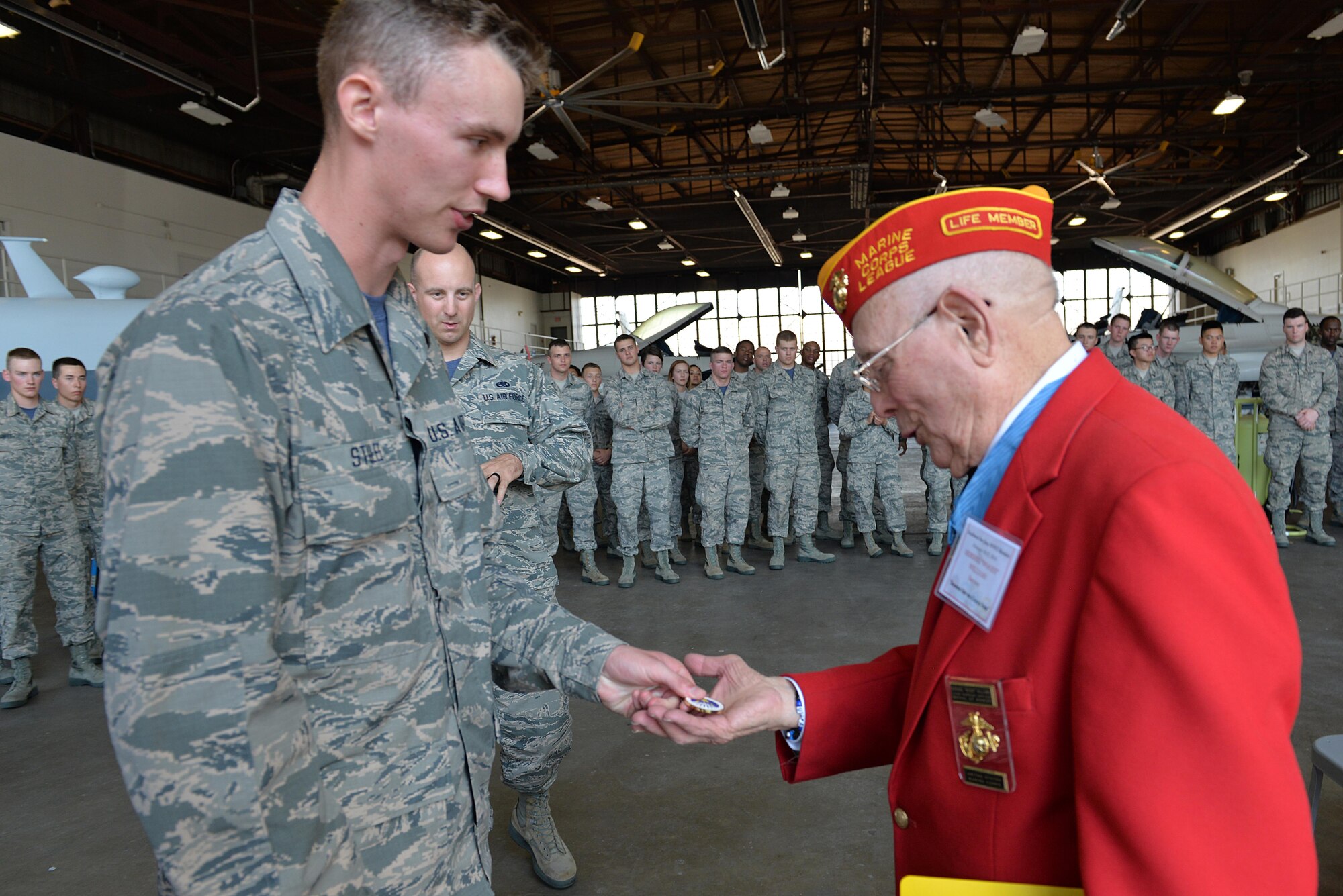 Leadership selected their youngest Airman, Derek Stiles, 362nd Training Squadron Airman in Training, to coin Hershel “Woody” Williams, Medal of Honor recipient, during his detour from the Iwo Jima reunion at Sheppard Air Force Base, Texas, Feb. 19, 2016. Williams took a detour from the reunion to visit with Airmen and speak about their oath and every day assumptions made about today’s service members. (U.S. Air Force photo/Senior Airman Kyle Gese)