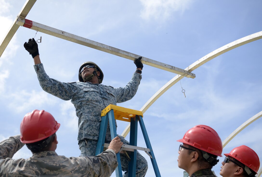 Republic of Singapore Air Force Military Expert 6 Nagenthiran Thurairaj, 508th Engineer Squadron commanding officer, assembles a frame for a small shelter system during Partner Nation Silver Flag, Feb. 13, 2016, at Andersen Air Force, Guam. Silver Flag is a U.S. Pacific Command multilateral Theater Security Cooperation Program subject matter expert exchange event designed to build partnerships and promote interoperability through the equitable exchange of civil engineer related information. This is the first multilateral Partner Nation Silver Flag. (U.S. Air Force photo by Senior Airman Joshua Smoot/Released)