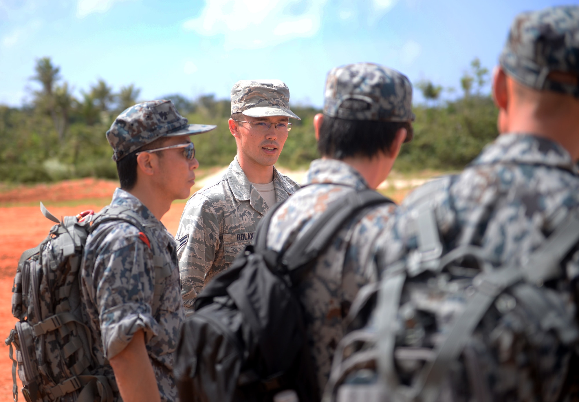 U.S. Air Force Airman 1st Class Daniel Roland, 792nd Intelligence Support Squadron cyber system operator, Joint Base Pearl Harbor-Hickam, Hawaii, translates information from 554th RED HORSE Squadron Silver Flag instructors to Japan Air Self-Defense Force engineers during Partner Nation Silver Flag, Feb. 14, 2016, at Andersen Air Force Base, Guam. Translators were selected throughout the Pacific Air Forces to help with the language barrier presented by the multiple nations involved in the PNSF. (U.S. Air Force photo by Senior Airman Joshua Smoot/Released)