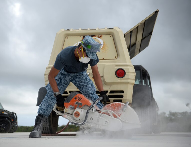 Republic of Singapore Air Force Military Expert 2 Wei Han Tan, a crater repair instructor, uses a pavement saw while repairing chips in an airfield during Partner Nation Silver Flag Feb. 14, 2016, at Andersen Air Force Base, Guam. The exercise was a small part of the first Partner Nation Silver Flag exercise, an event where partner nations were presented the opportunity to travel to Guam to trade engineering practices with each other and the U.S. Air Force.. (U.S. Air Force photo/Senior Airman Joshua Smoot)