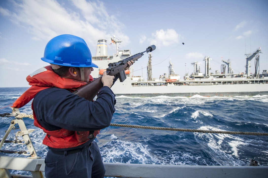 Navy Petty Officer 2nd Class T. Westmoreland fires a shot line from the USS Gonzalez during a replenishment at sea with the USNS Joshua Humphreys in the Persian Gulf, Feb. 14, 2016. Westmoreland is a gunner's mate Navy photo by Petty Officer 3rd Class Pasquale Sena