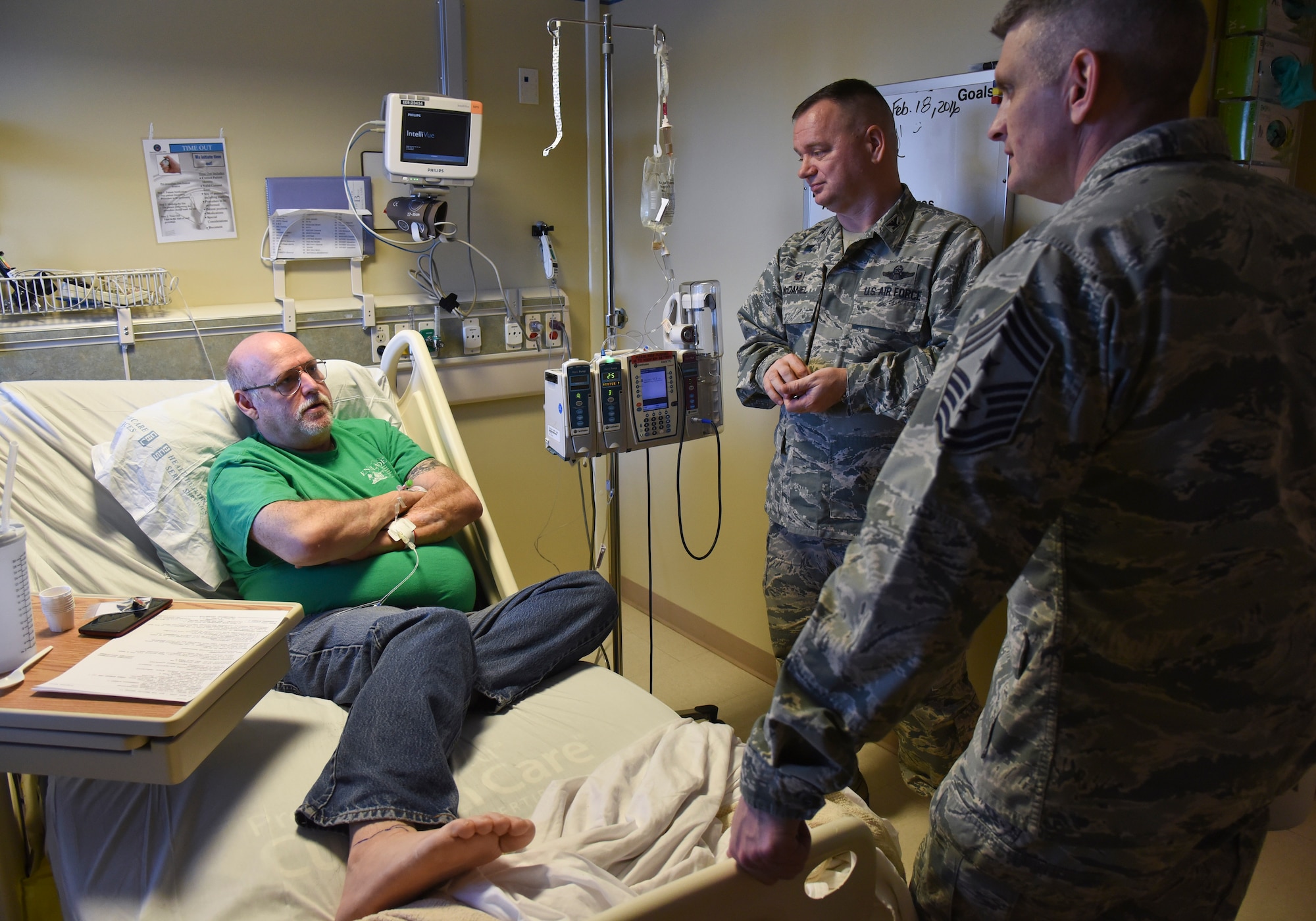 Col. Brian McDaniel, 92nd Air Refueling Wing commander, and Chief Master Sgt. Christian Pugh, 92nd ARW command chief, visit with Bob Sternberg, retired Air Force pararescuman, during National Salute to Veteran Patients Week Feb. 18, 2016, at Mann-Grandstaff VA Medical Center in Spokane, Wash. During the week, a variety of events are hosted at VA medical centers nationwide to increase community awareness, pay tribute, express appreciation to veterans and encourage citizens to become involved as volunteers. (U.S. Air Force photo/Airman 1st Class Mackenzie Richardson)