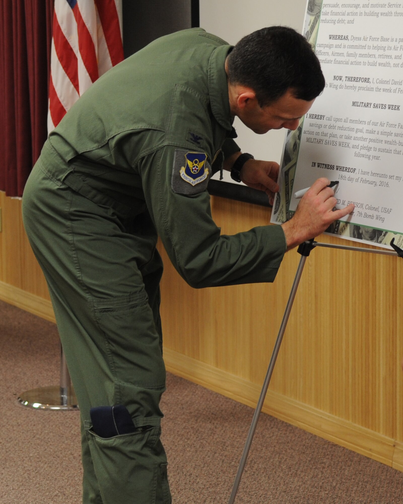 U.S. Air Force Col. David Benson, 7th Bomb Wing commander, signs the Military Saves Week proclamation Feb. 18, 2016, at Dyess Air Force Base, Texas. To help promote the importance of managing finances, the Department of Defense Military Saves Week program focuses on the importance of saving and investing for the future.  (U.S. Air Force photo by Senior Airman Shannon Hall/Released)