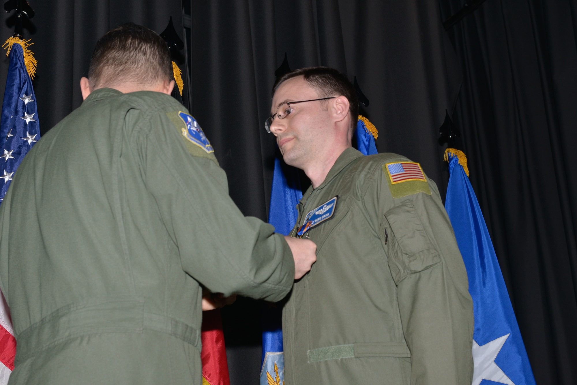 Master Sgt. Boris Brink, 37th Airlift Squadron operations superintendent, gets The Air Medal pinned on by Lt. Gen. Timothy Ray, 3rd Air force and 17th Expeditionary Air Force commander, Feb. 19, 2016, at Ramstein Air Base, Germany. Brink received the prestigious award for demonstrating exemplary airmanship and professionalism to safely recover an Aircraft during an emergency ramp-open landing. (U.S. Air Force/Airman 1st Class Lane T. Plummer)