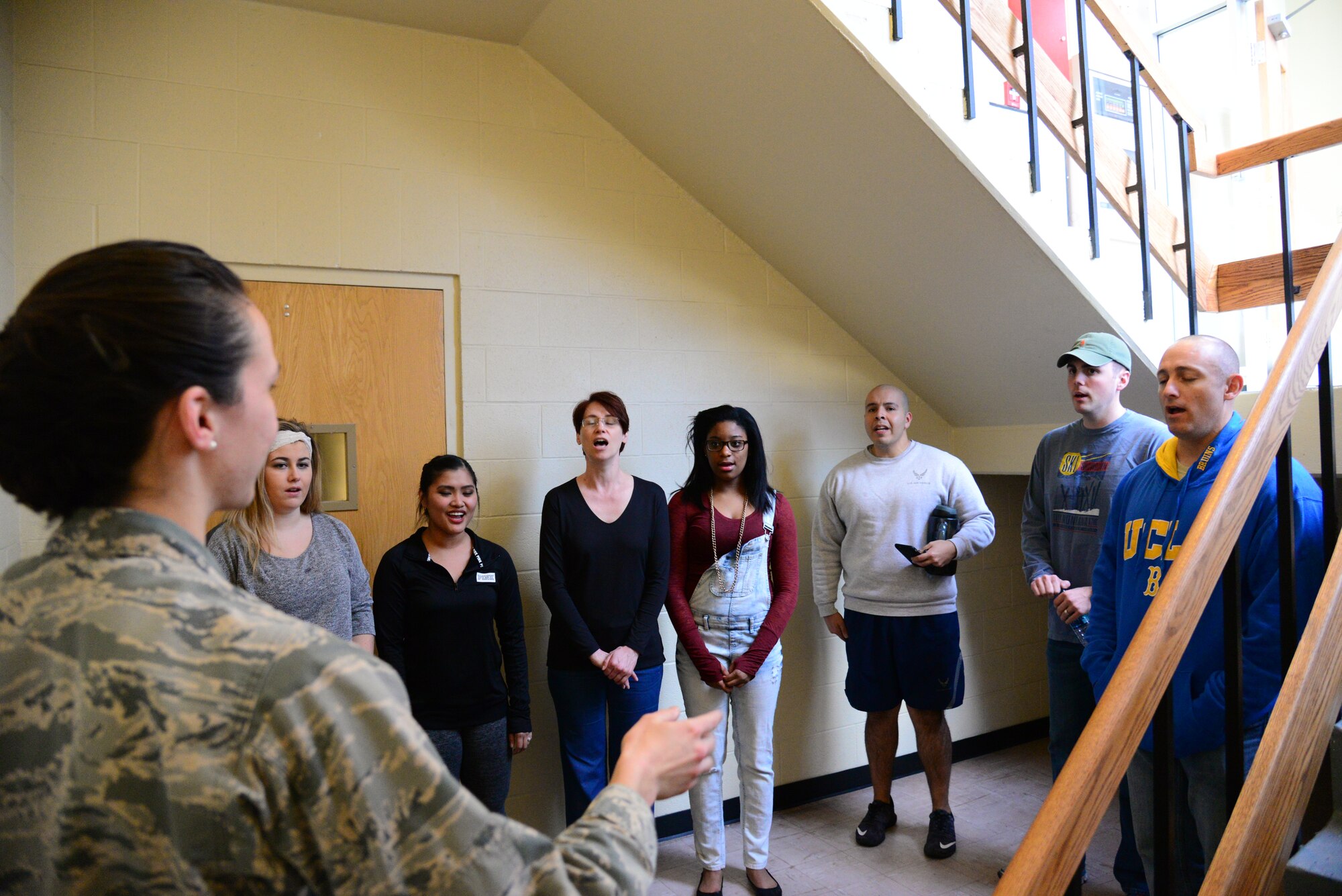 1st Lt. Deanna Kerkhoff, 341st Contracting Squadron contract specialist and co-conductor/director of the Malmstrom Air Force Base Choir, leads the choir during practice Feb. 16, 2016, at Malmstrom Air Force Base, Mont. The choir will sing a four-part harmony of the national anthem for its first performance on Feb. 19 at the Malmstrom Annual Awards ceremony. (U.S. Air Force photo/Airman 1st Class Magen M. Reeves)