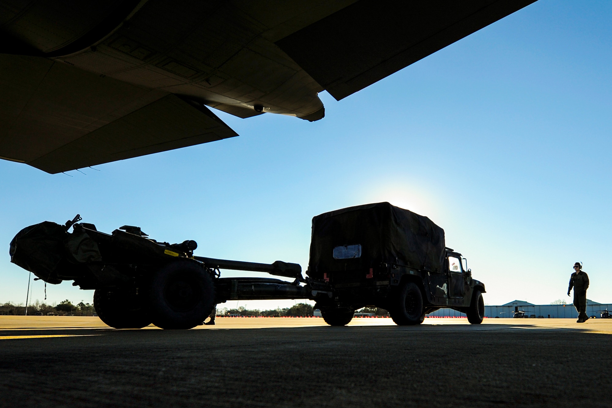 A U.S. Air Force C-130J loadmaster prepares to upload a Humvee and Howitzer Cannon onto a C-130J during GREEN FLAG 16-04 Feb. 17, 2016, at Alexandria International Airport, La. The C-130 can accommodate a wide variety of oversized cargo, including utility helicopters, six-wheeled armored vehicles, standard palletized cargo and military personnel (U.S. Air Force photo/Senior Airman Harry Brexel)