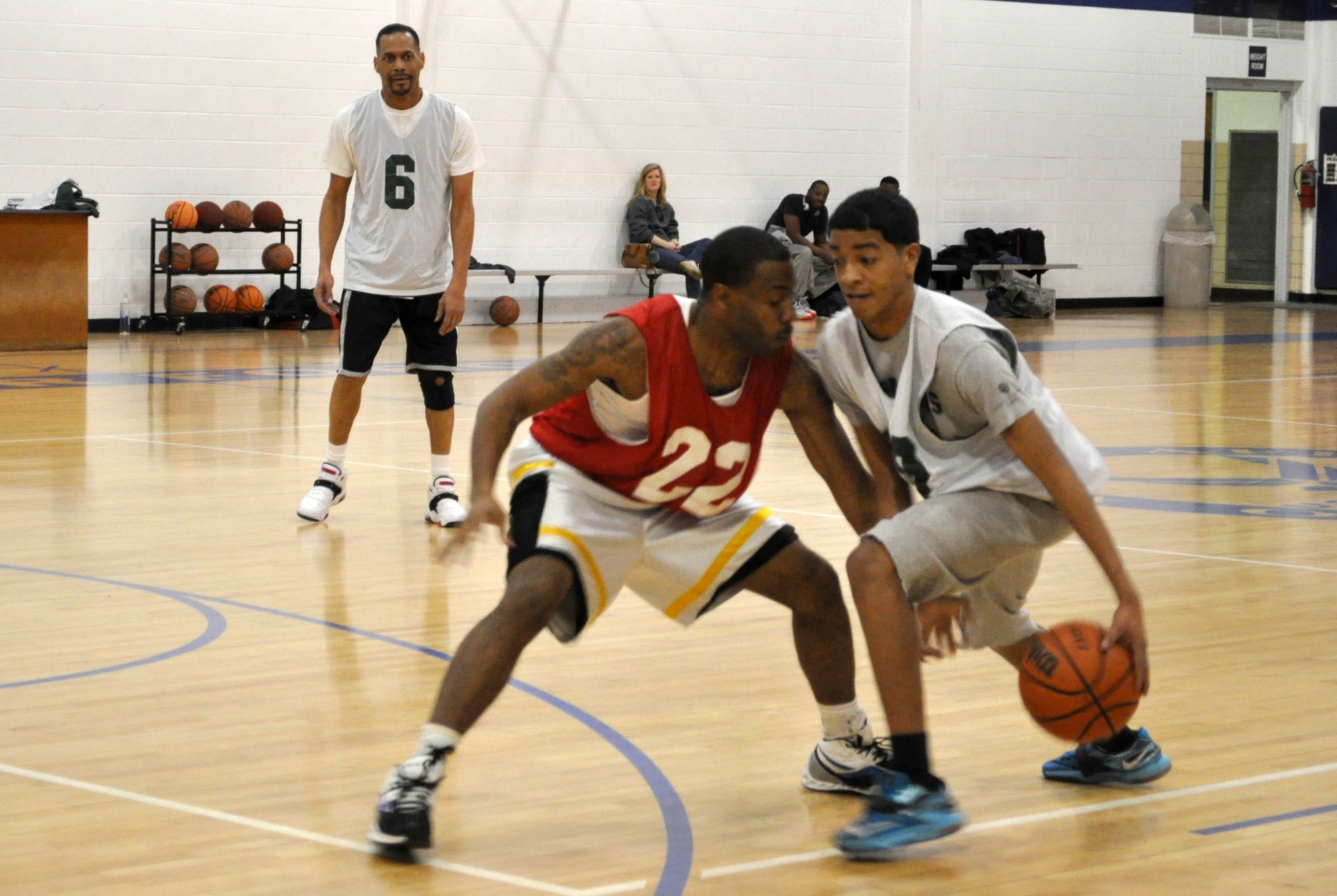 Terrell Turner with 72 LRS busts a move against 752 OSS’s Ryan during a Feb. 9 game that OSS won 47-40 at the Gerrity Fitness Center. No. 6 is Wendall Curry.  (Air Force photo by John Parker/Released)