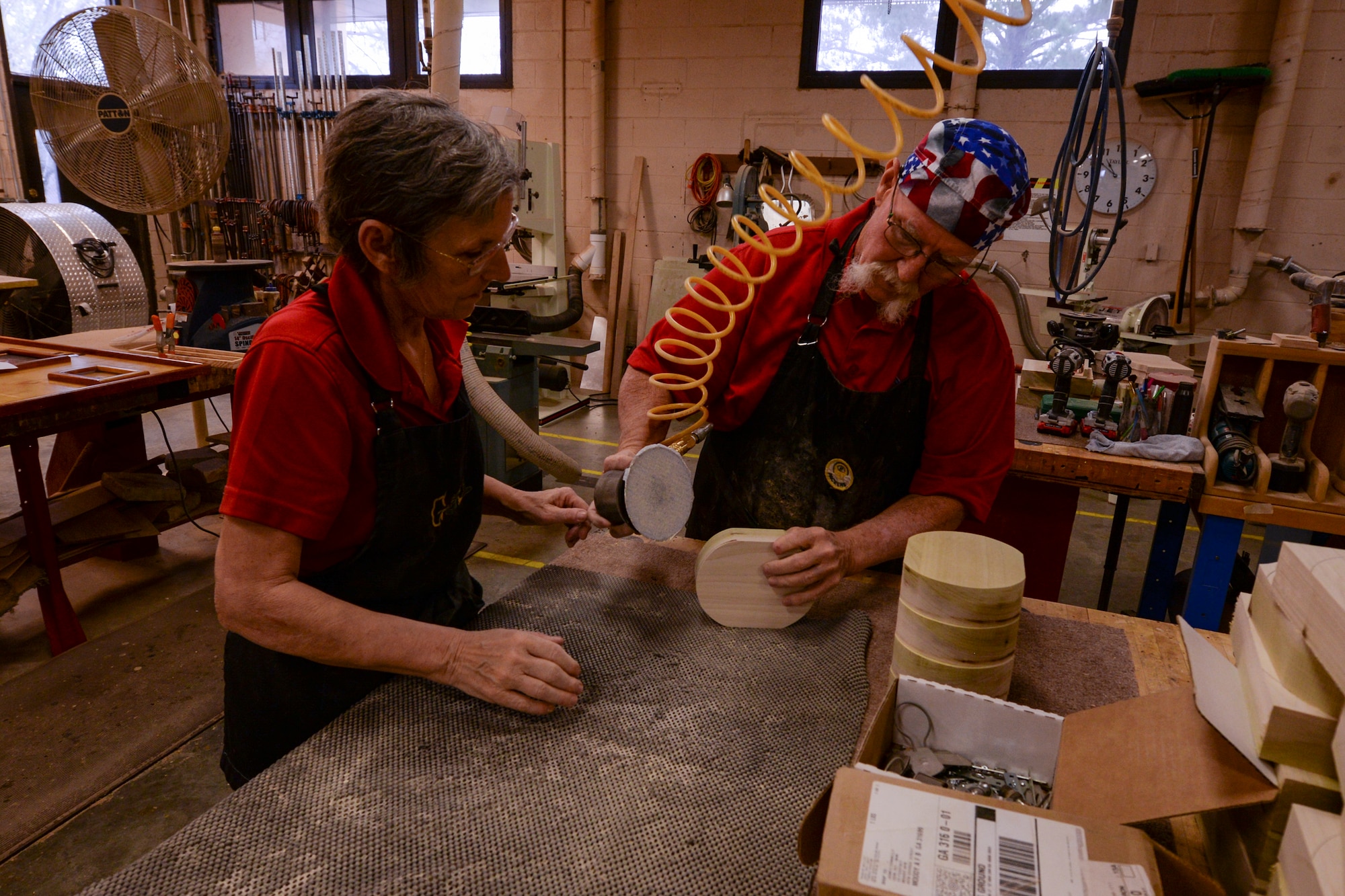 John Fischbach Sr., 23d Force Support Squadron recreation aide and Gail Fischbach, 23d FSS volunteer, sand woodblocks Jan. 15, 2016, at Moody Air Force Base, Ga. Gail and John work in the Woodshop, and enjoy making masterpieces for the local community. (U.S. Air Force photo by Airman 1st Class Janiqua P. Robinson/Released)