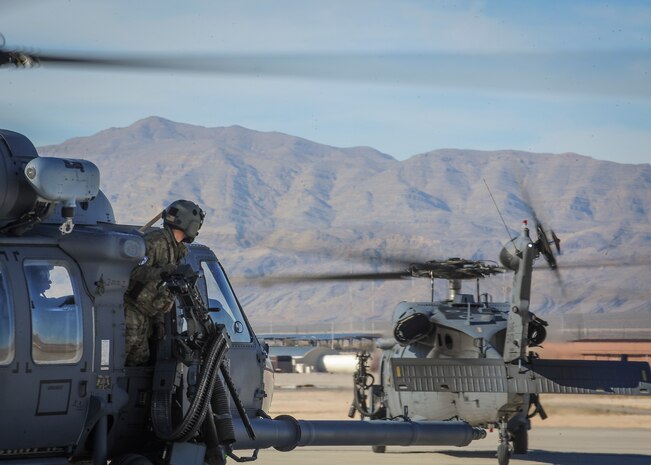 Airman 1st Class David Hayes, 210th Rescue Squadron special mission aviator from Joint Base Elmendorf-Richardson, Alaska, looks out the side of an HH-60 helicopter before taking off during Red Flag 16-1 Feb. 11, 2016, at Nellis Air Force Base, Nev. Being from Alaska, the 210th RQS participates in Red Flag exercises held at Eielson Air Force Base, Alaska, where they provide combat search and rescue. (U.S. Air Force photo by Senior Airman Jake Carter) 