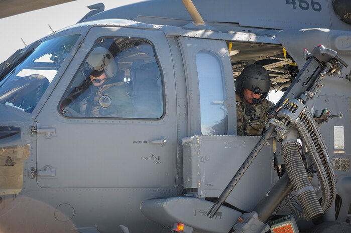 1st Lt. Seth Peterson, pilot, and Senior Master Sgt. Thomas Dietrich, special mission aviator from the 210th Rescue Squadron, Joint Base Elmendorf-Richardson, Alaska, conduct pre-flight checks in preparation for take-off during Red Flag 16-1 Feb. 11, 2016, at Nellis Air Force Base, Nev. Attached to each HH-60 are two .50 caliber machine guns where if the crew comes in contact with an enemy, they can return fire. (U.S. Air Force photo by Senior Airman Jake Carter)