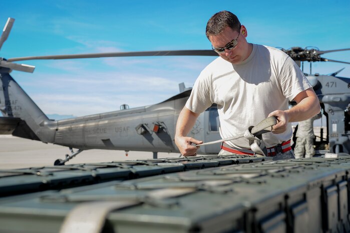 Master Sgt. Bishop Bailey, 176th Aircraft Maintenance Squadron weapons section chief from Joint Base Elmendorf-Richardson, Alaska, straps down ammunition canisters during pre-flight procedures for a sortie during Red Flag 16-1 Feb. 11, 2016, at Nellis Air Force Base, Nev. During Red Flag, the 210th Rescue Squadron is responsible for providing combat search and rescue and air support for ground units. (U.S. Air Force photo by Senior Airman Jake Carter)