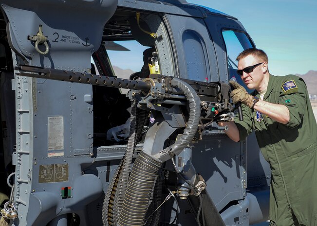 Airman 1st Class David Hayes, 210th Rescue Squadron special mission aviator from Joint Base Elmendorf-Richardson, Alaska, inspects a GAU-18.50 caliber machine gun in preparation for a sortie during Red Flag 16-1 Feb. 11, 2016, at Nellis Air Force Base, Nev. During the exercise, members of the 210th RQS worked hand in hand with pilots and ground units to provide combat search and rescue. (U.S. Air Force photo by Senior Airman Jake Carter)