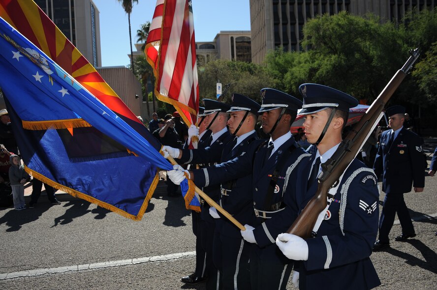 U.S. Airmen from the Davis-Monthan Air Force Base honor guard march in formation during a Veterans Day Parade in Tucson, Ariz., Nov 11, 2015. The base honor guard is responsible for 49,602 square miles. This included events held in Tucson to the border of New Mexico, west to Ajo, Ariz., and then south to the border of Mexico. (U.S. Air Force photo by Airman 1st Class Ashley Steffen/ Released)