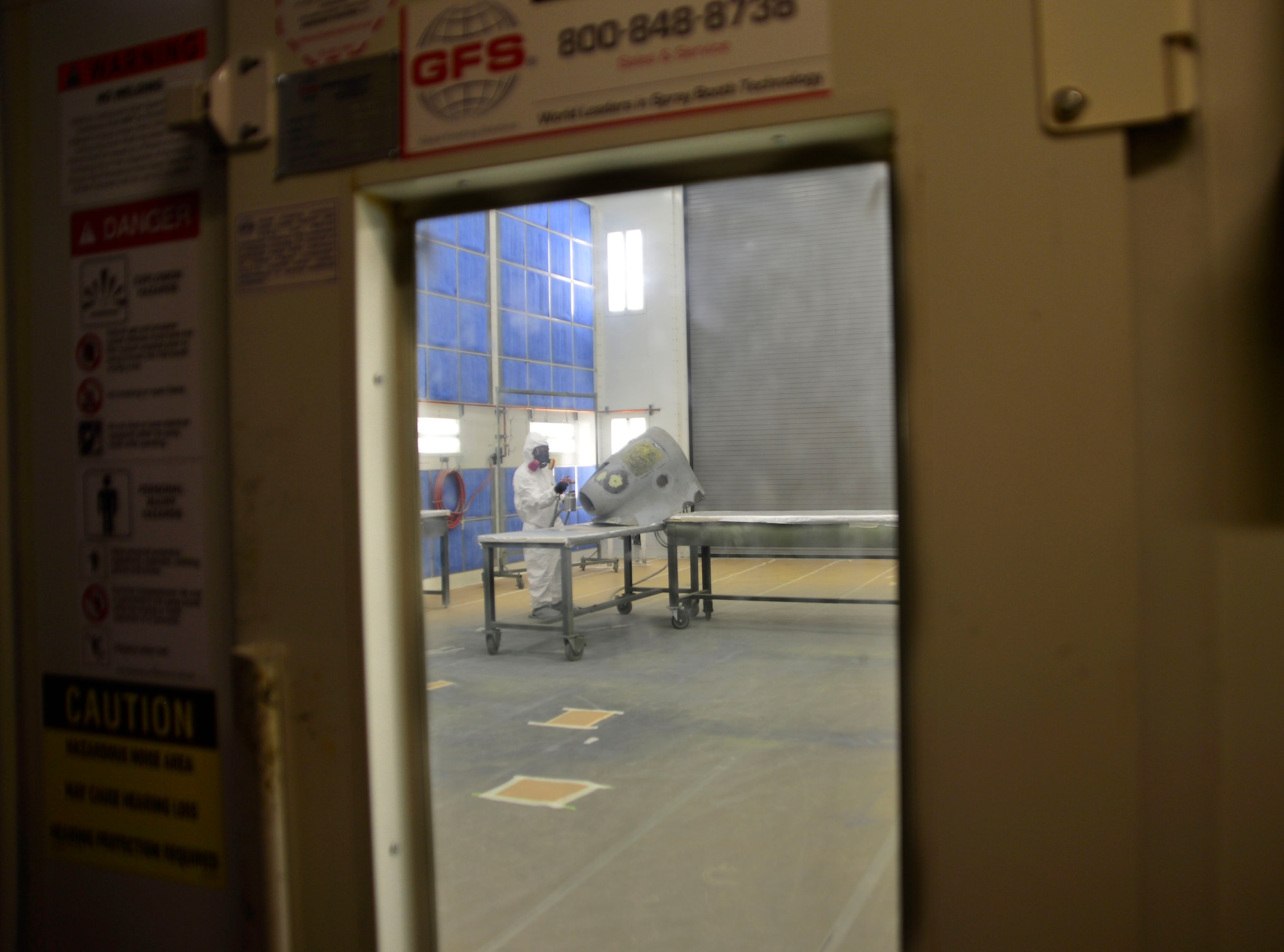 Senior Airman Joshua, 432nd Maintenance Squadron aircraft structural maintenance journeyman paints a panel for the MQ-9 Reaper Feb. 18, 2016, at Creech Air Force Base, Nevada. Aircraft structural maintenance at Creech AFB, because of the composite structure of the MQ-1 Predator and MQ-9 Reaper remotely piloted aircraft, is a very tedious job. During the repair process even if one layer of carbon fiber, Kevlar, or fiberglass is improperly bonded, it could result in a mistake that still renders the aircraft unable to fly, making the shop start the process over from scratch.  (U.S. Air Force photo by Senior Airman Christian Clausen/Released)