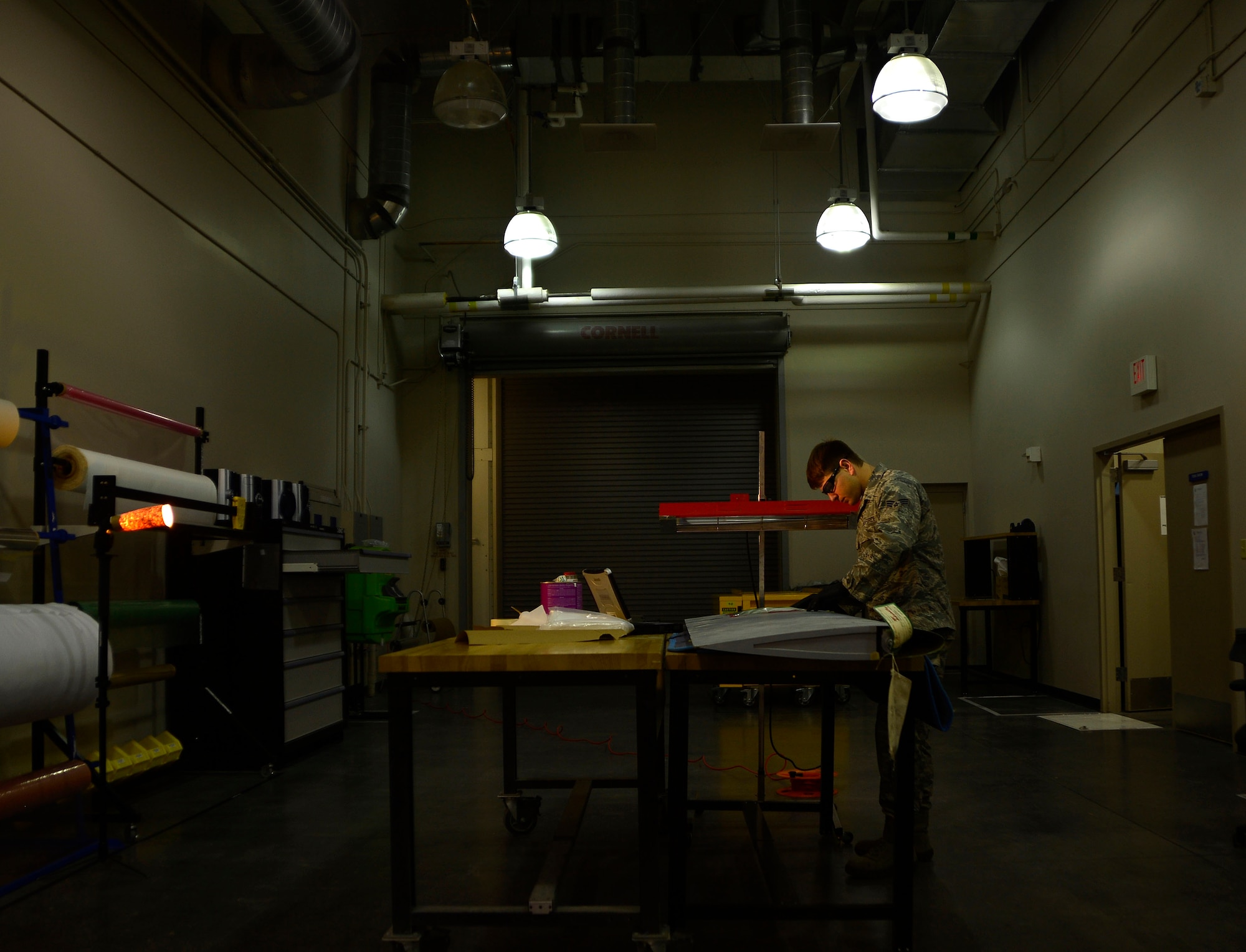 Senior Airman Brian, 432nd Maintenance Squadron aircraft structural maintenance journeyman lays down layers of composite fabric used to repair a MQ-1 Predator wing panel Feb. 18, 2016, at Creech Air Force Base, Nevada. Without the structural maintenance shop, flaws caused by wear and tear, moisture absorption, or other structural damages would eventually cause the aircraft to become structurally unsound and not airworthy. Aircraft structural maintenance is extremely important because an aircraft that can’t fly is not only a loss of money for the Air Force, but also in the remotely piloted aircraft enterprise, reduces the situational awareness available to the joint commanders thus making structural maintenance a job that must be taken seriously. (U.S. Air Force photo by Senior Airman Christian Clausen/Released)