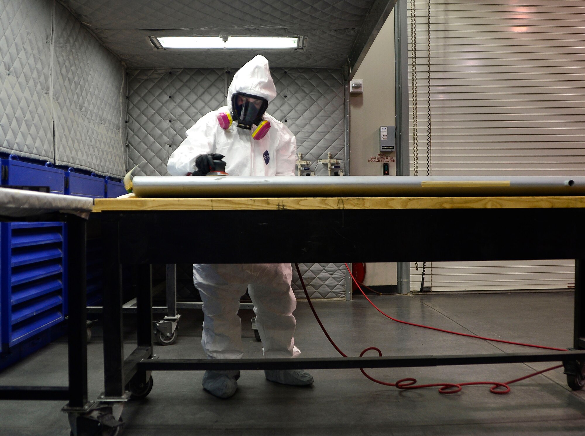 Senior Airman Joshua, 432nd Maintenance Squadron aircraft structural maintenance journeyman sands down a wing panel for the MQ-1 Predator Feb. 18, 2016, at Creech Air Force Base, Nevada. The MQ-1 Predator and MQ-9 Reaper are made completely of composite materials such as carbon fiber, Kevlar, and specialized variations of fiberglass. Because of this, the structural maintenance Airmen must wear proper protective equipment to keep the hazardous carbon shavings and paint from being inhaled. (U.S. Air Force photo by Senior Airman Christian Clausen/Released)
