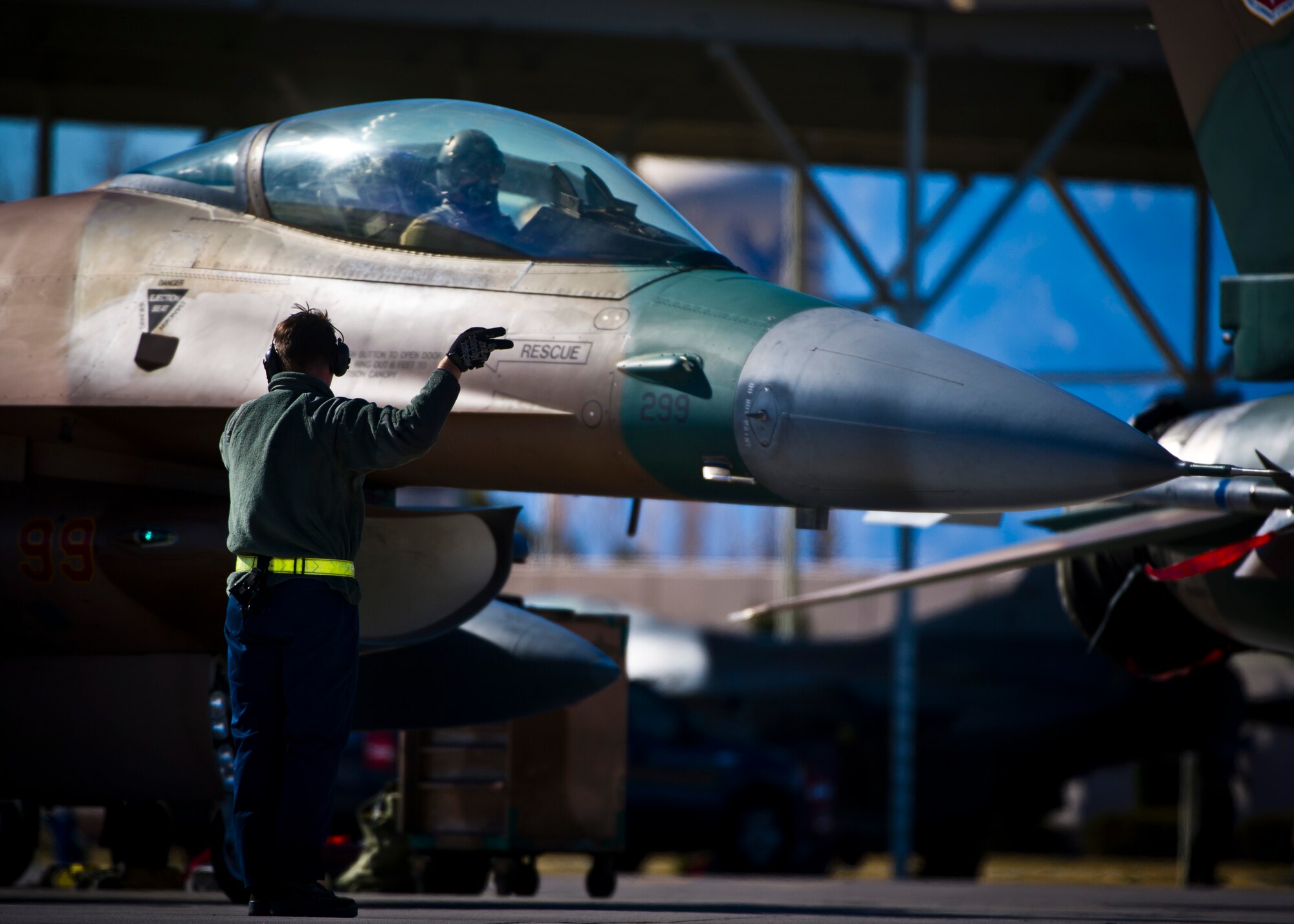 Senior Airman Erik Garza, 57th Aircraft Maintenance Squadron crew chief, marshals out Lt. Col. Jan Stahl, 926th Operations Group F-16 Fighting Falcon pilot, for a training mission during Red Flag 16-1 on Feb. 5, 2016, at Nellis Air Force Base, Nev. The 926th Aircraft Maintenance Squadron here augments the 57th AMXS with full-time Reserve manpower to accomplish the maintenance mission on a daily basis. (U.S. Air Force photo/Senior Airman Brett Clashman)
