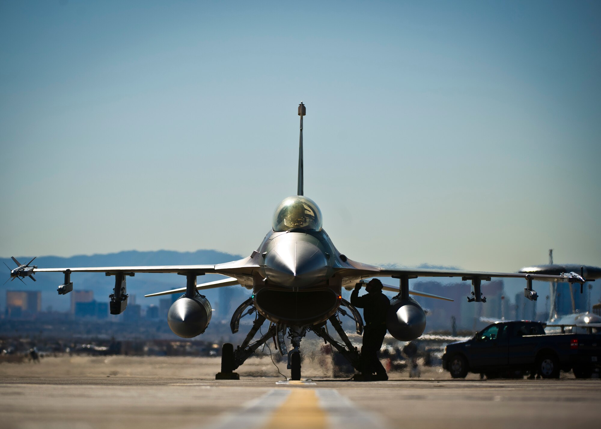 Senior Airman Erik Garza, 57th Aircraft Maintenance Squadron crew chief, conducts pre-flight maintenance while Lt. Col. Jan Stahl, 926th Operations Group F-16 Fighting Falcon pilot, performs pre-checks before a training mission during Red Flag 16-1 on Feb. 5, 2016, at Nellis Air Force Base, Nev. The 926th OG is a U.S. Air Force Reserve unit whose members are integrated into Nellis' day-to-day operations, working side by side their Regular Air Force counterparts. (U.S. Air Force photo/Senior Airman Brett Clashman)