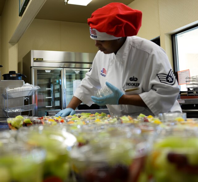 Staff Sgt. Jamie Hooker, 60th Force Support Squadron food service specialist, prepares fruit cups Feb. 16 at Travis Air Force Base, California. An important part of food services job is food preparation and dissemination to the eight food service locations on base. (U.S. Air Force photo by Airman 1st Class Amber Carter)