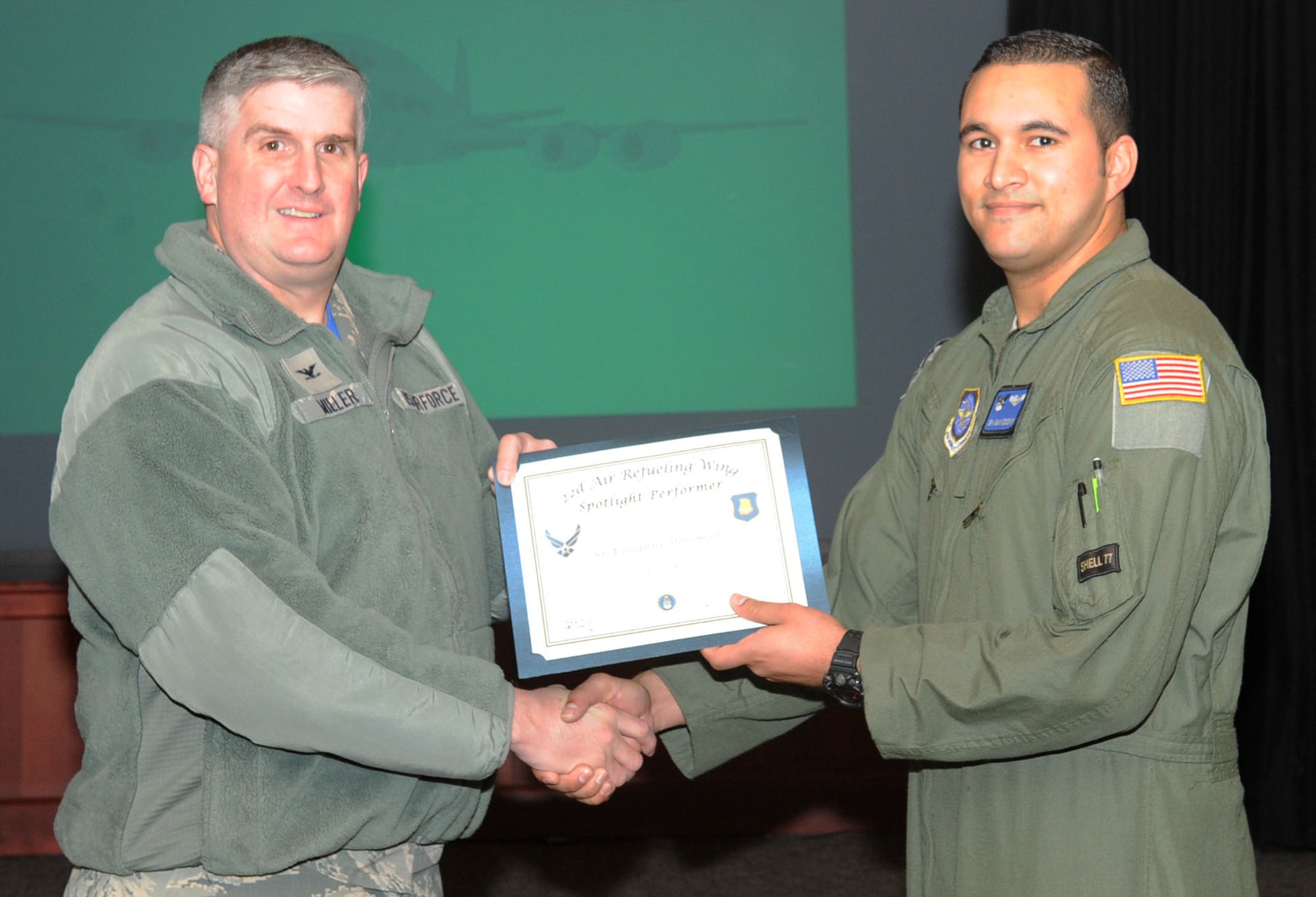 Senior Airman Giani Dossman, 344th Air Refueling Squadron instructor boom operator, poses with Col. Albert Miller, 22nd Air Refueling Wing commander, Feb. 12, 2016, at McConnell Air Force Base, Kan. As an instructor boom operator, Dossman is responsible for the direct training of new boom operators, those seeking re-qualification and others preparing to attend instructor school. Dossman received the spotlight performer for the week of Feb. 1-5, but he was on a temporary duty assignment. (U.S. Air Force photo/Senior Airman David Bernal Del Agua)