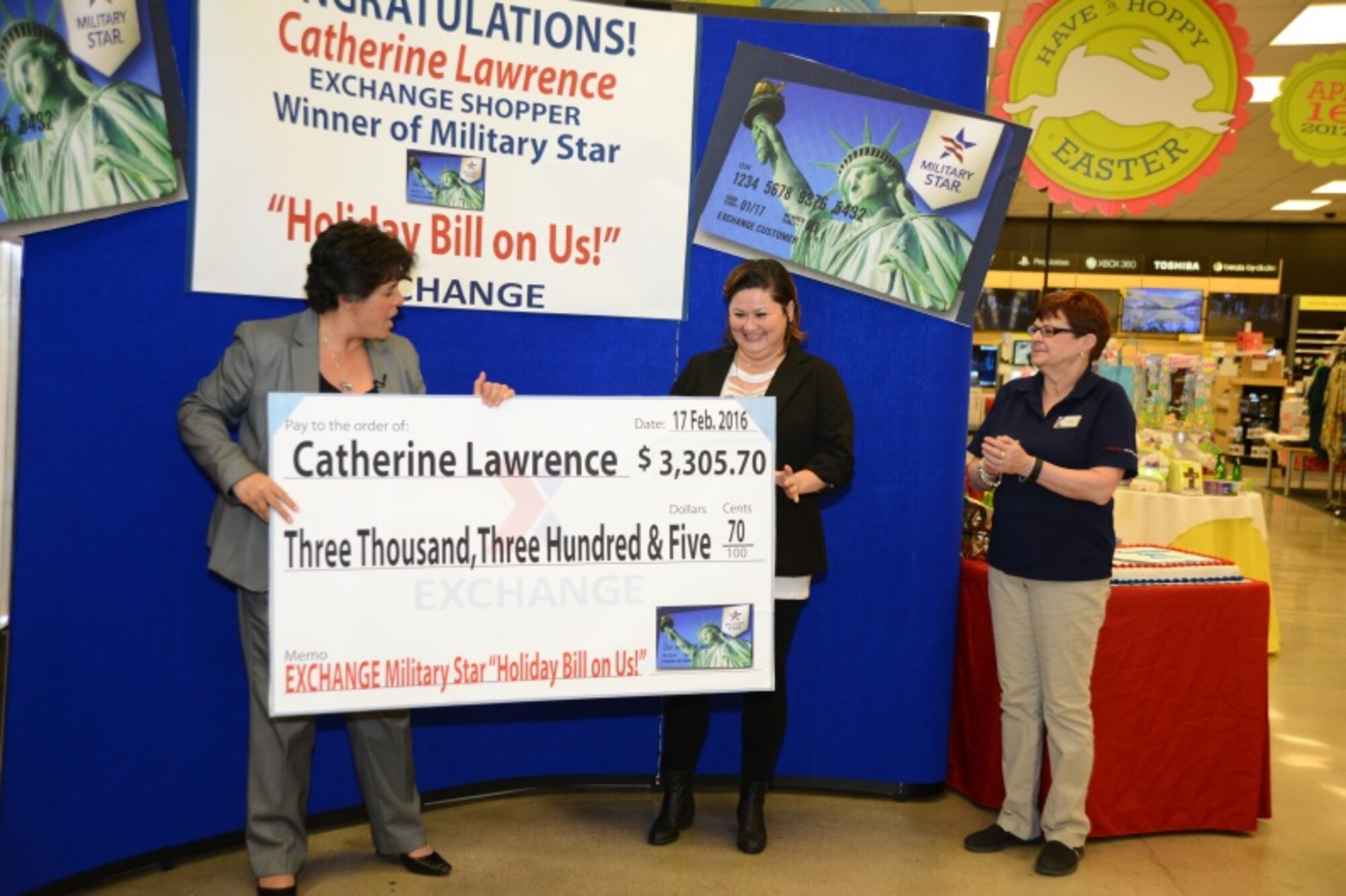 Robin M. Ayling, left, McConnell Air Force Base and Fort Riley Exchange Service general manager, presents a check to retired Master Sgt. Catherine Lawrence, Feb. 17, 2016, at McConnell Air Force Base, Kan. Lawrence won a check valued over $3,300 to cover her holiday expenses, by using her Military Star card from the beginning of November to end of December, the period when card users were entered into the sweepstakes. (U.S. Air Force photo/Airman 1st Class Christopher Thornbury)