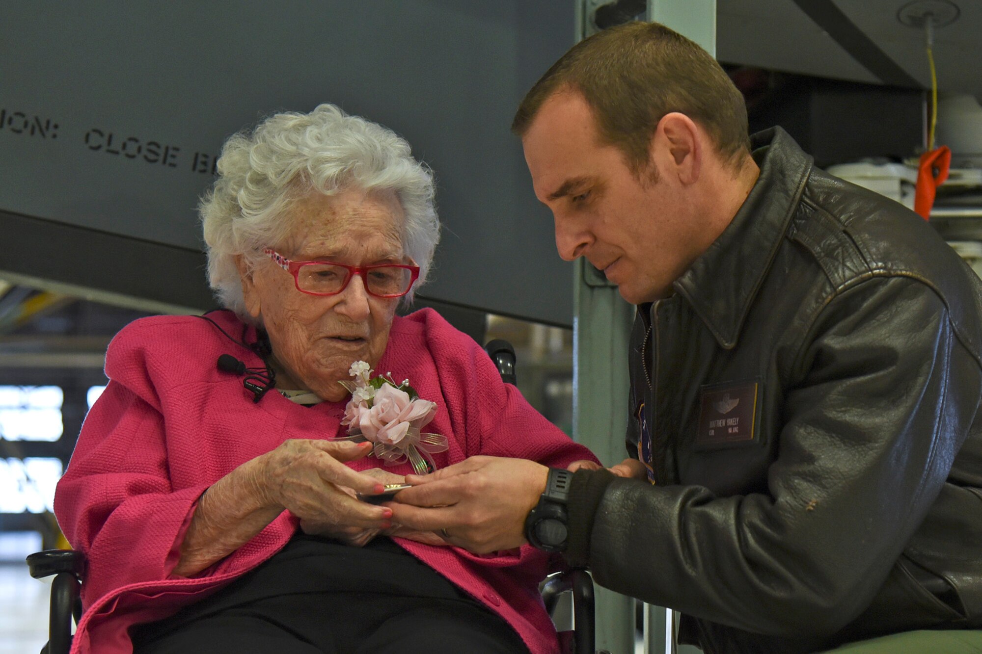 Col. Matthew Yakely, 141st Operations Group commander, gives an Air Force coin to Ms. Flossie Dickey Feb. 19, 2016, at Fairchild Air Force Base, Wash. Fairchild leadership helped celebrate Flossie’s 110th birthday by recognizing her as a Fairchild Honorary Airman. (U.S. Air Force photo/Airman 1st Class Mackenzie Richardson)