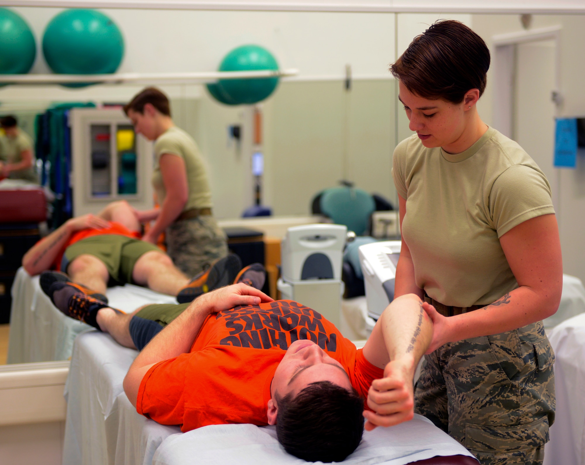 Staff Sgt. Sage Summers, 86th Medical Operations Squadron physical therapy technician, helps her patient, Staff Sgt. Bryan Bevard, 86th Operations Support Squadron, through his physical therapy session Feb. 3, 2016, at Ramstein Air Base, Germany. Patients are treated by being guided through their recovery until they are fully fit. (U.S. Air Force photo/Tech. Sgt. Kristopher Levasseur)