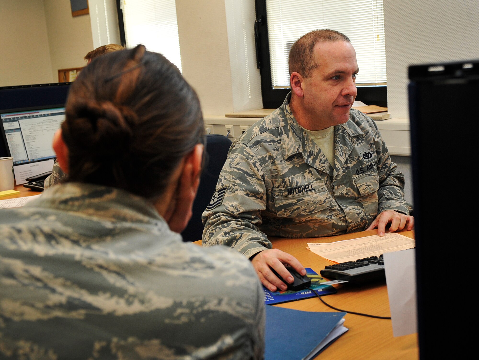 Tech. Sgt. David Mitchell, 786th Civil Engineer Squadron payments and construction equipment NCO in charge, assists Senior Airman Kathryn Patchoski, 569th U.S. Forces Police Squadron police services NCO, with her tax return at the tax center Feb. 18, 2016, at Ramstein Air Base, Germany. The tax center assisted in $2.1 million in refunds in 2014. (U.S. Air Force photo/Airman 1st Class Larissa Greatwood)