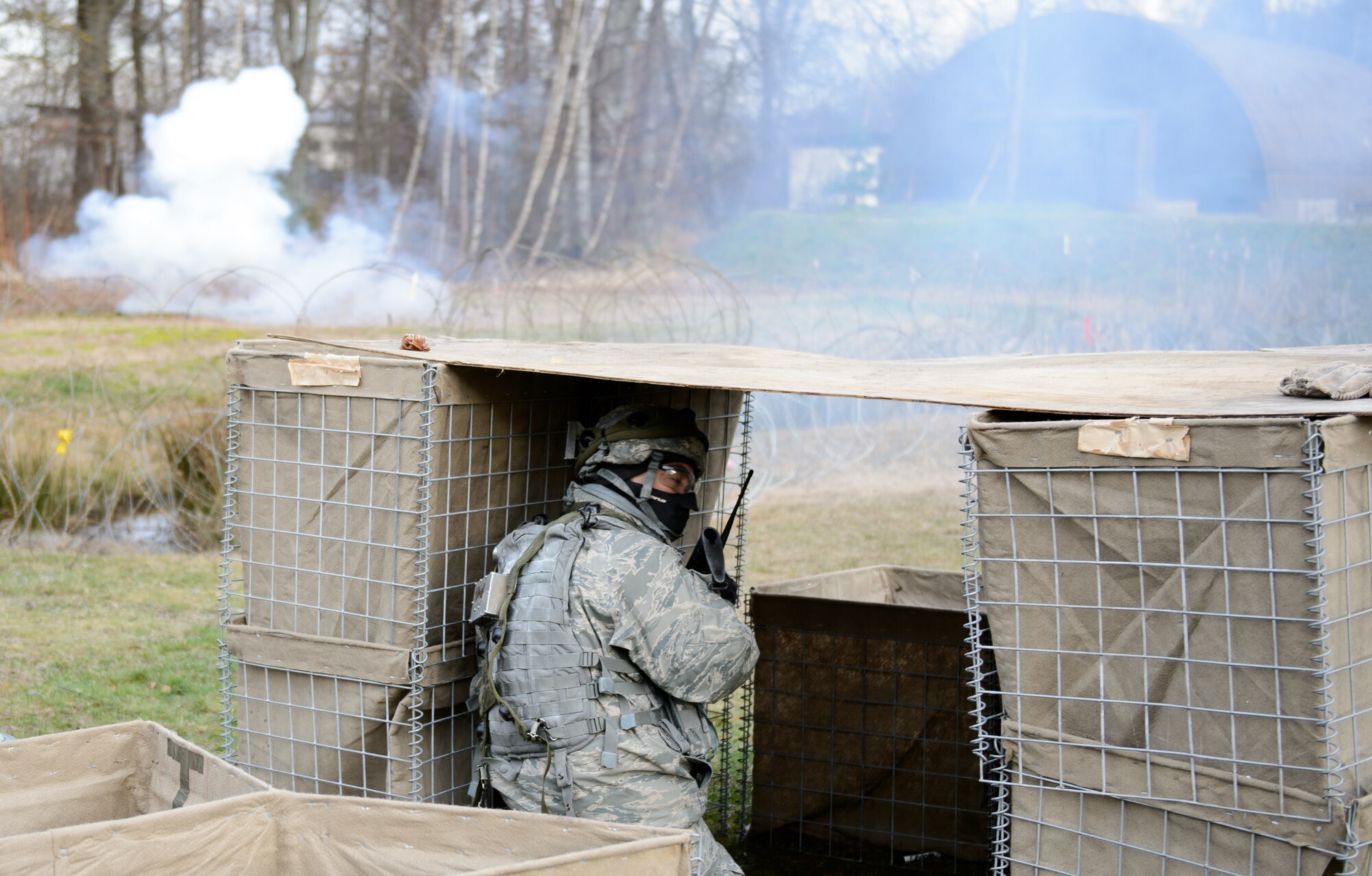 A 1st Combat Communications Squadron Airman calls back as instructors release mock mortars on the compound Feb. 12, 2016, at Ramstein Air Base, Germany. The 1st CBCS conducts regular deployment skills training to prepare Airmen for any situation they may encounter. (U.S. Air Force photo/Staff Sgt. Armando A. Schwier-Morales)