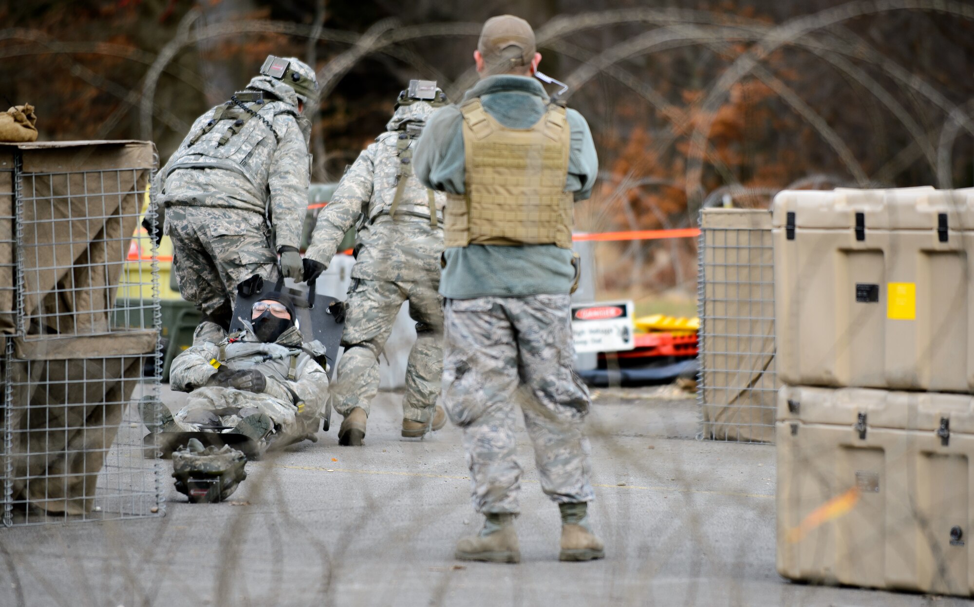 A 1st Combat Communications Squadron instructor watches as trainees drag a “wounded” Airman away to a mock field hospital Feb. 12, 2016, at Ramstein Air Base, Germany. The Airmen are training to maintain deployment skills to ensure be able to defend their multi-million dollars of assets. (U.S. Air Force photo/Staff Sgt. Armando A. Schwier-Morales)