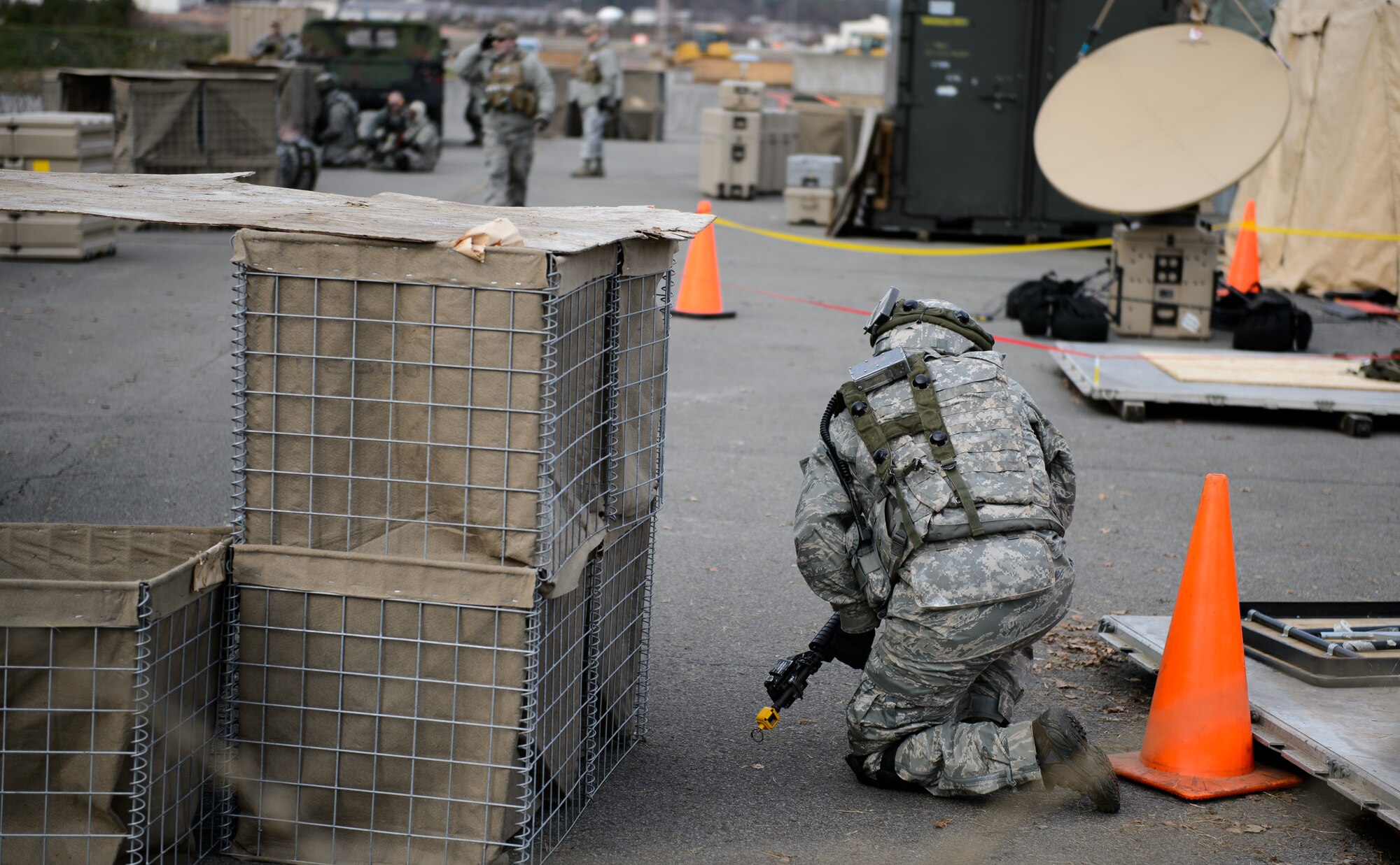 A 1st Combat Communications Squadron Airman takes cover as opposition forces begin their mock attack on trainees at Ramstein Air Base, Germany Feb. 12, 2016. The 1st CBCS constantly trains Airmen to hone their skills they may need while deployed to a variety of locations across the world. (U.S. Air Force photo/Staff Sgt. Armando A. Schwier-Morales)