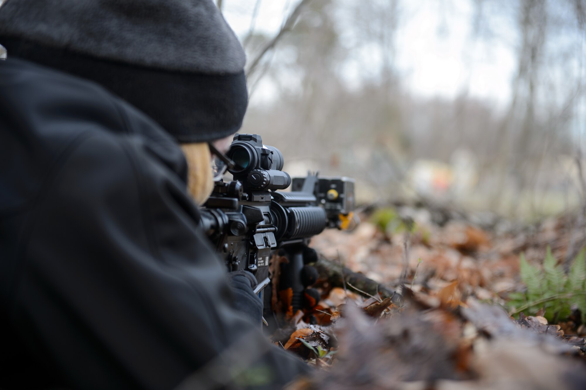 An opposition forces Airman aims at a 1st Combat Communications Squadron base during a mock fire fight at Ramstein Air Base, Germany Feb. 12, 2016. Airmen from a variety of career fields volunteer to increase the realism of training scenarios and keep 1st CBCS Airmen well trained. (U.S. Air Force photo/Staff Sgt. Armando A. Schwier-Morales)