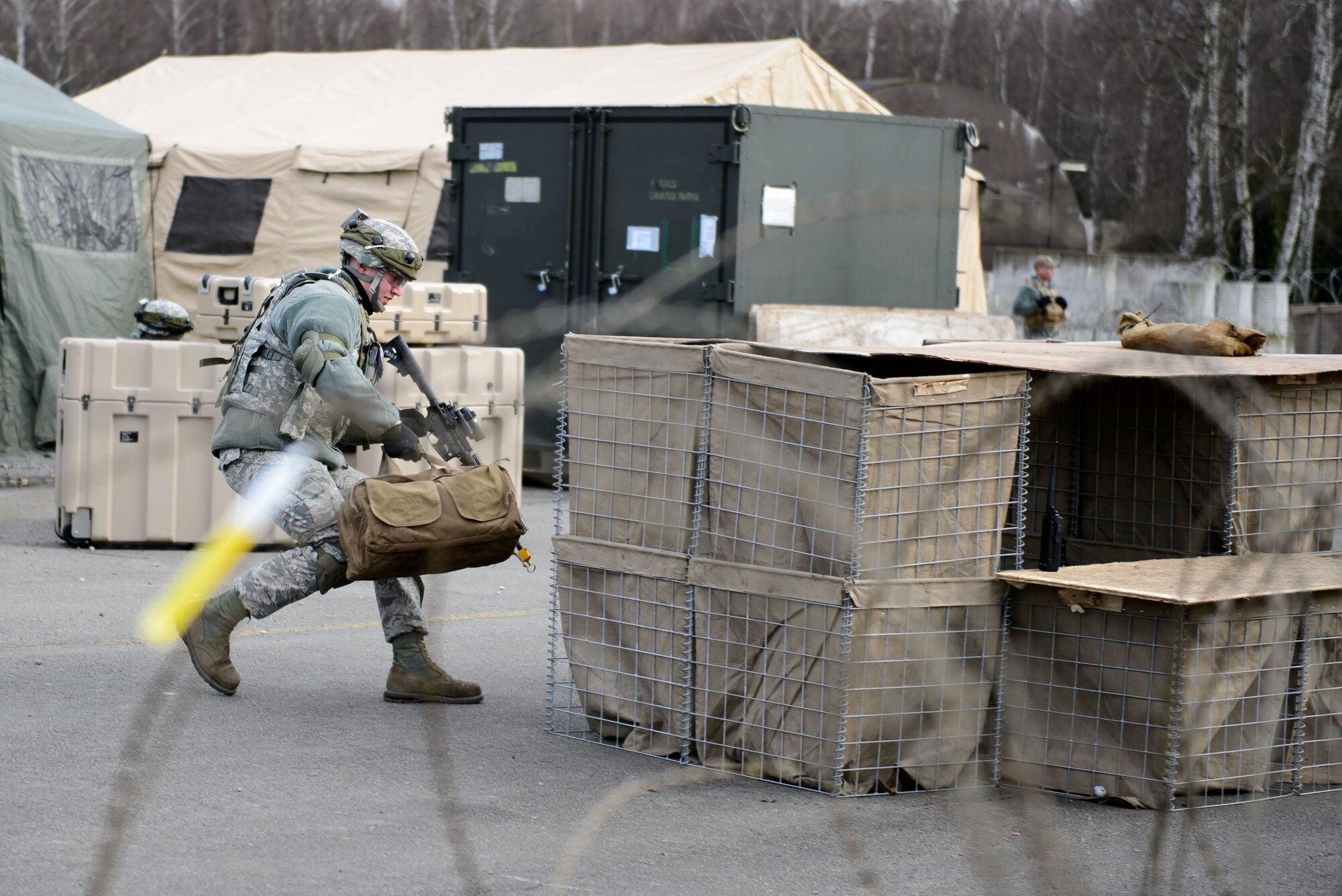 Senior Airman Zachery Davis, 1st Combat Communications Squadron electrical power production technician, positions himself to counter a mock opposition forces attack on Ramstein Air Base, Germany Feb. 12, 2016. The 1st CBCS trains Airmen in a variety of scenarios as they may deploy to any part of the European and African theaters. (U.S. Air Force photo/Staff Sgt. Armando A. Schwier-Morales)