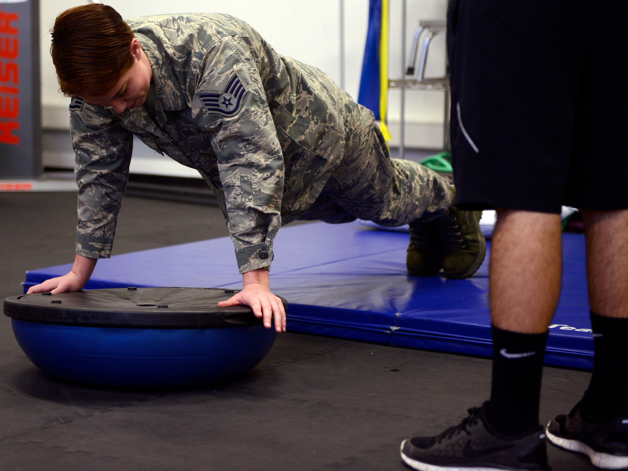 Staff Sgt. Sage Summers, 86th Medical Operations Squadron physical therapy technician, demonstrates how to properly perform a balancing exercise during his physical therapy session Feb. 3, 2016, at Ramstein Air Base, Germany. Airmen from the 86th MDOS help guide patients through series of exercise routines to get them back to health. (U.S. Air Force photo/Tech. Sgt. Kristopher Levasseur)