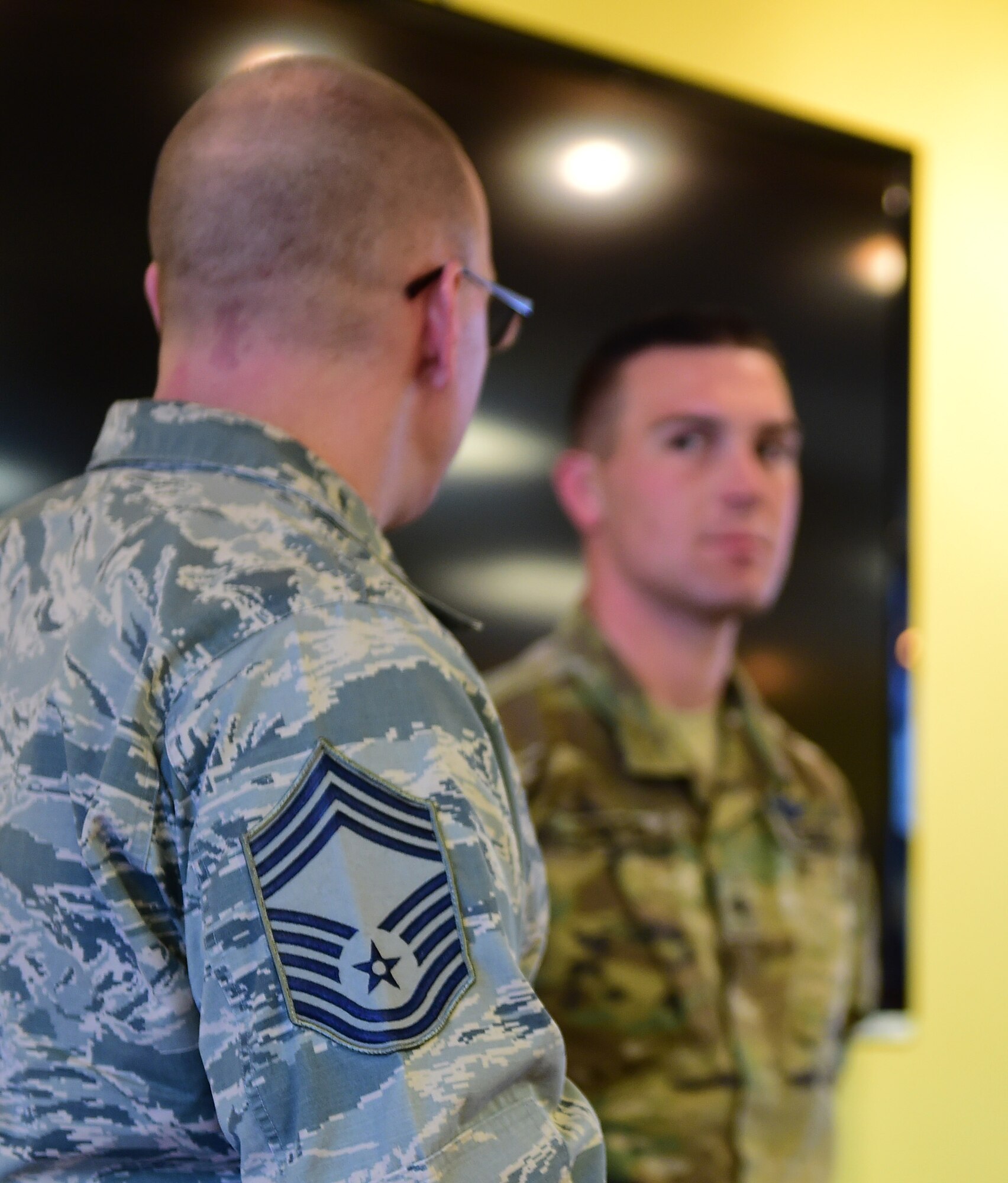 U.S. Air Force Chief Master Sgt. Richard Halseth, Team Buckley Chief’s Group member, speaks about the accomplishments of U.S. Army Spc. Brian Carter, 743d Military Intelligence Battalion analyst, at the Panther Den Feb. 18, 2016, on Buckley Air Force Base, Colo. The Chief’s Group recognized Carter for going above and beyond the call of duty. (U.S. Air Force photo by Senior Airman Racheal E. Watson/Released) 