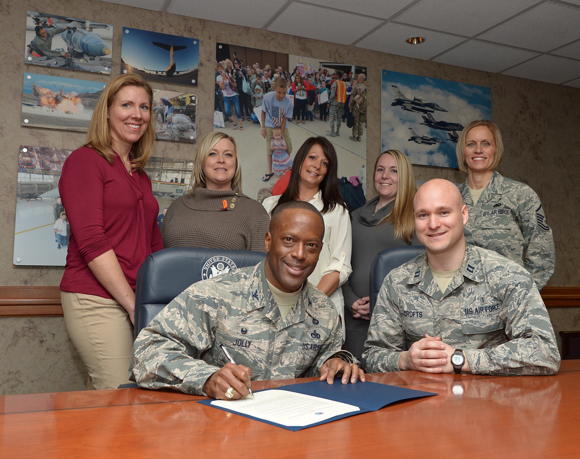 75th Air Base Wing Commander Col. Ronald E. Jolly, Sr. signs a Teen Dating Awareness proclamation Feb. 10 at Hill Air Force Base, Utah. Teen dating violence is an epidemic that affects youth in every community across the nation, including Hill AFB. Members of the Family Advocacy Outreach office were also present during the signing. (U.S. Air Force photo/Alex R. Lloyd)