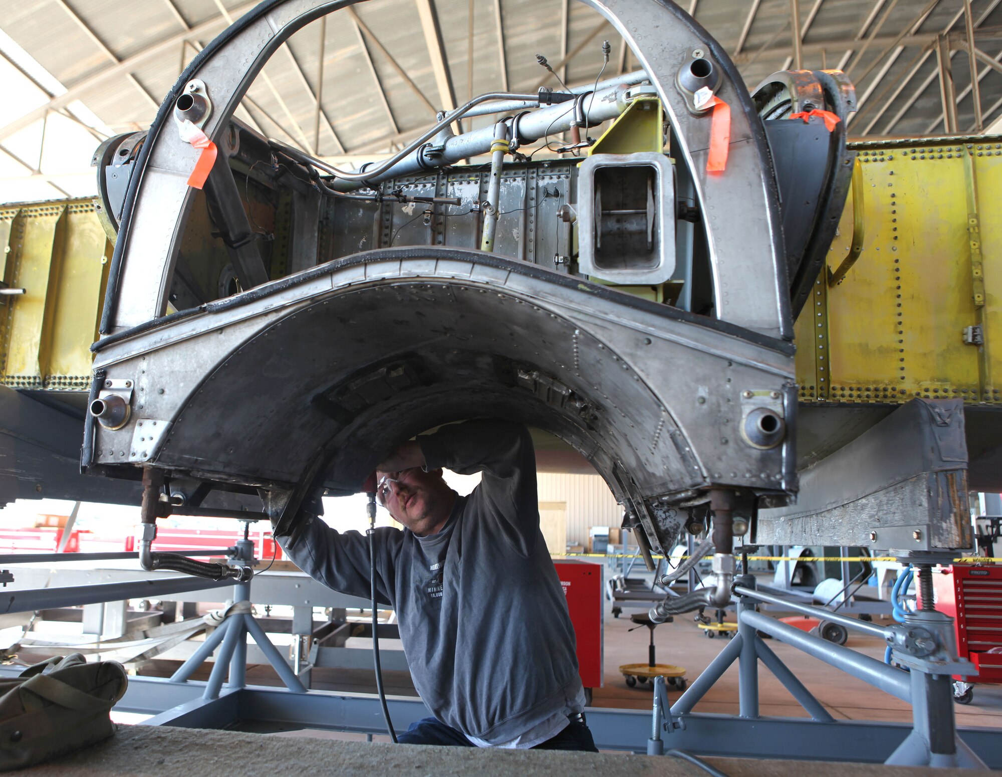 Rick Barrett, an AMARG sheet metal expert, removes a truss mount’s lower attach bolts as part of the required OW-13 inspection on a C-130E outer wing.  The refurbished wing will be sent to Robins AFB, Ga. in support of the M-130H programmed maintenance depot effort. (Air Force photo)