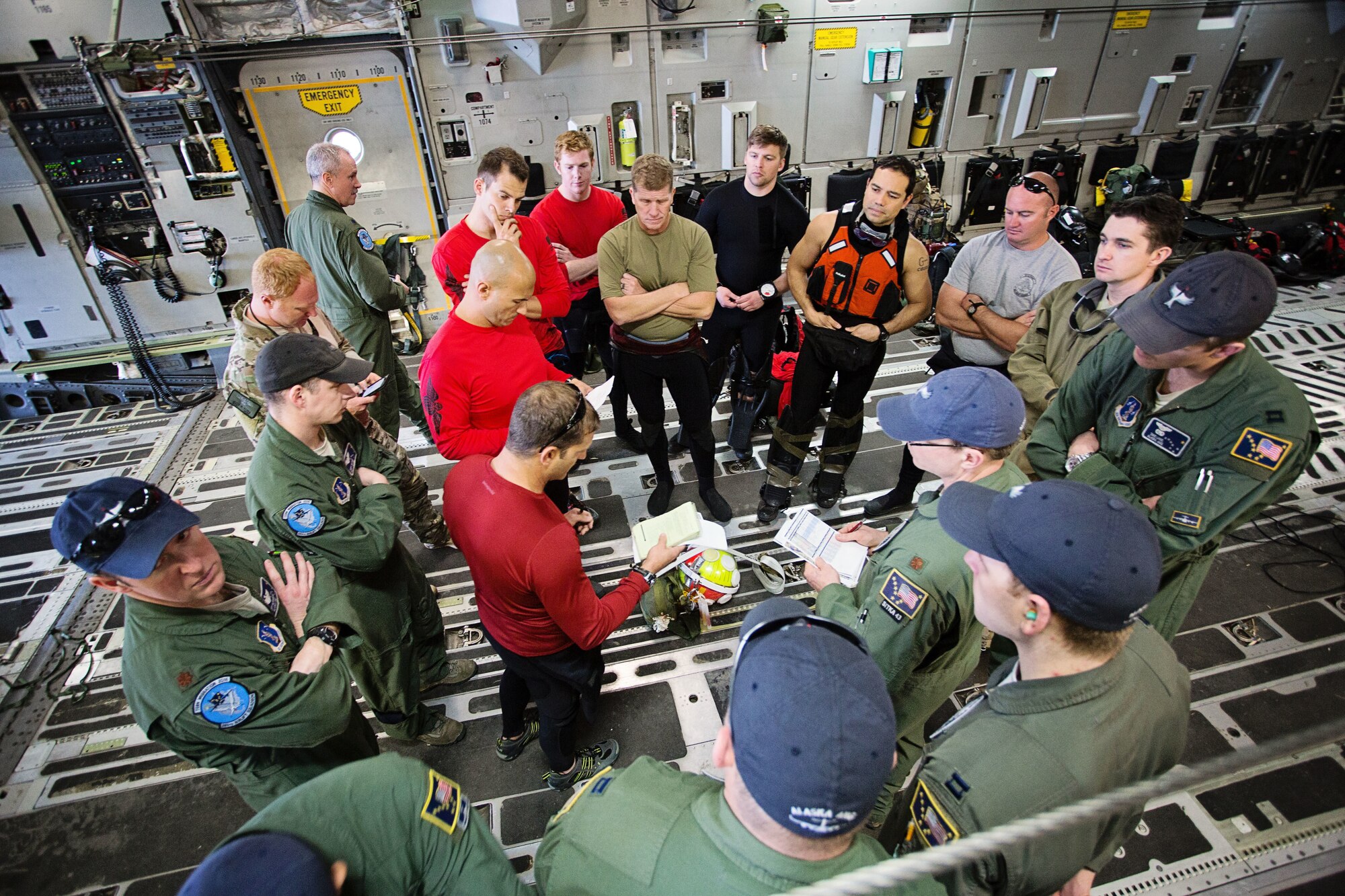Members of the 920th Rescue Wing and the 249th Airlift Squadron conduct a pre-mission briefing aboard a C-17 Globemaster III aircraft at Patrick Air Force Base, Fla., Jan. 14 before departing for a simulated astronaut rescue mission. The 249th AS worked with NASA, the 920th Rescue Wing, the 45th Space Wing and Detachment 3 of the 45th Operations Group to develop tactics, training and procedures to quickly and safely recover astronauts in the event they would need to abort their spacecraft. (Courtesy photo by Senior Airman Zac Heinen)