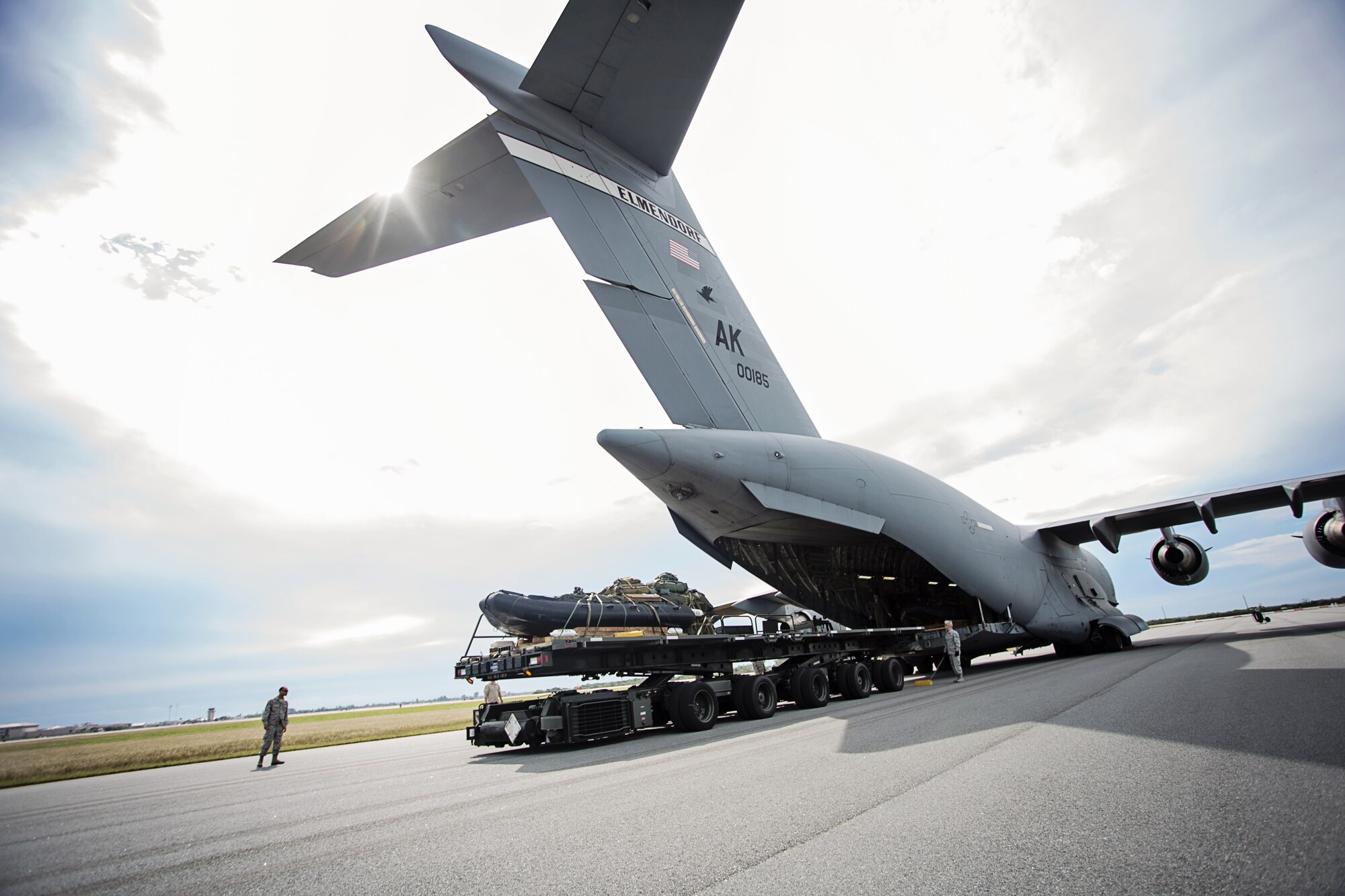 A team from the 920th Rescue Wing loads a Rigging Alternate Method Zodiac package onto a C-17 Globemaster III aircraft from the 249th Airlift Squadron, Alaska Air National Guard, at Patrick Air Force Base, Fla., Jan. 14 after packaging the equipment for an airdrop during a simulated astronaut recovery mission. The 249th AS worked with NASA, the 920th Rescue Wing, the 45th Space Wing and Detachment 3 of the 45th Operations Group to develop tactics, training and procedures to quickly and safely recover astronauts in the event they would need to abort their spacecraft. (Courtesy photo by Senior Airman Zac Heinen)