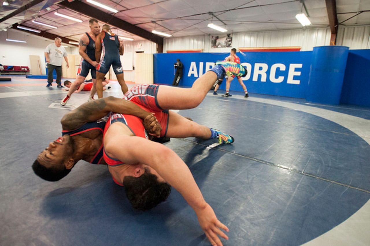 Senior Airman Brandon Johnson, Fairchild AFB, Wa., flips Senior Airman Jorge Hernandez, Hurlburt Field, Fla., while training for the Armed Forces Wrestling Championships. The team will compete in the Freestyle and Greco-Roman style in the tournament. (U.S. Air Force photo by Christian DeLuca/released)