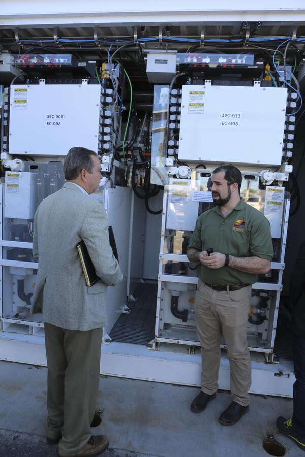 Mick Wasco, energy program manager for Marine Corps Air Station Miramar, Calif., explains to William Torre, a member of a Korean delegation, the uses of a Primus Power battery during the delegation’s visit aboard MCAS Miramar, Feb. 17. A Primus Power battery is a liquid battery used for energy storage on the electric grid aboard the installation. The delegation consisted of 14 South Korean citizens and two American citizens. (U.S. Marine Corps photo by Cpl. Kimberlyn Adams/Released)
