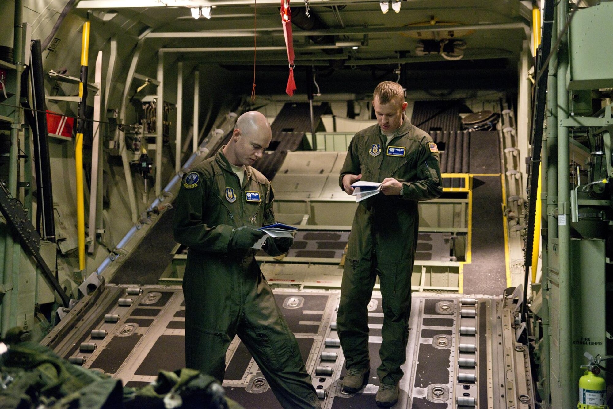 (L-R) U.S. Air Force Reserve Master Sgts. Tim Brown and Joshua Hames, conduct a preflight inspection in a C-130J fuselage trainer at the U.S. Air Force C-130 Aircrew Training System schoolhouse at Little Rock Air Force Base, Ark., Feb. 16, 2016. Both Airmen are loadmasters assigned to the 327th Airlift Squadron, 913th Airlift Group, at Little Rock AFB, and are in training as part of the group’s transition from the “H” model to the “J” model. (U.S. Air Force photo by Master Sgt. Jeff Walston/Released)